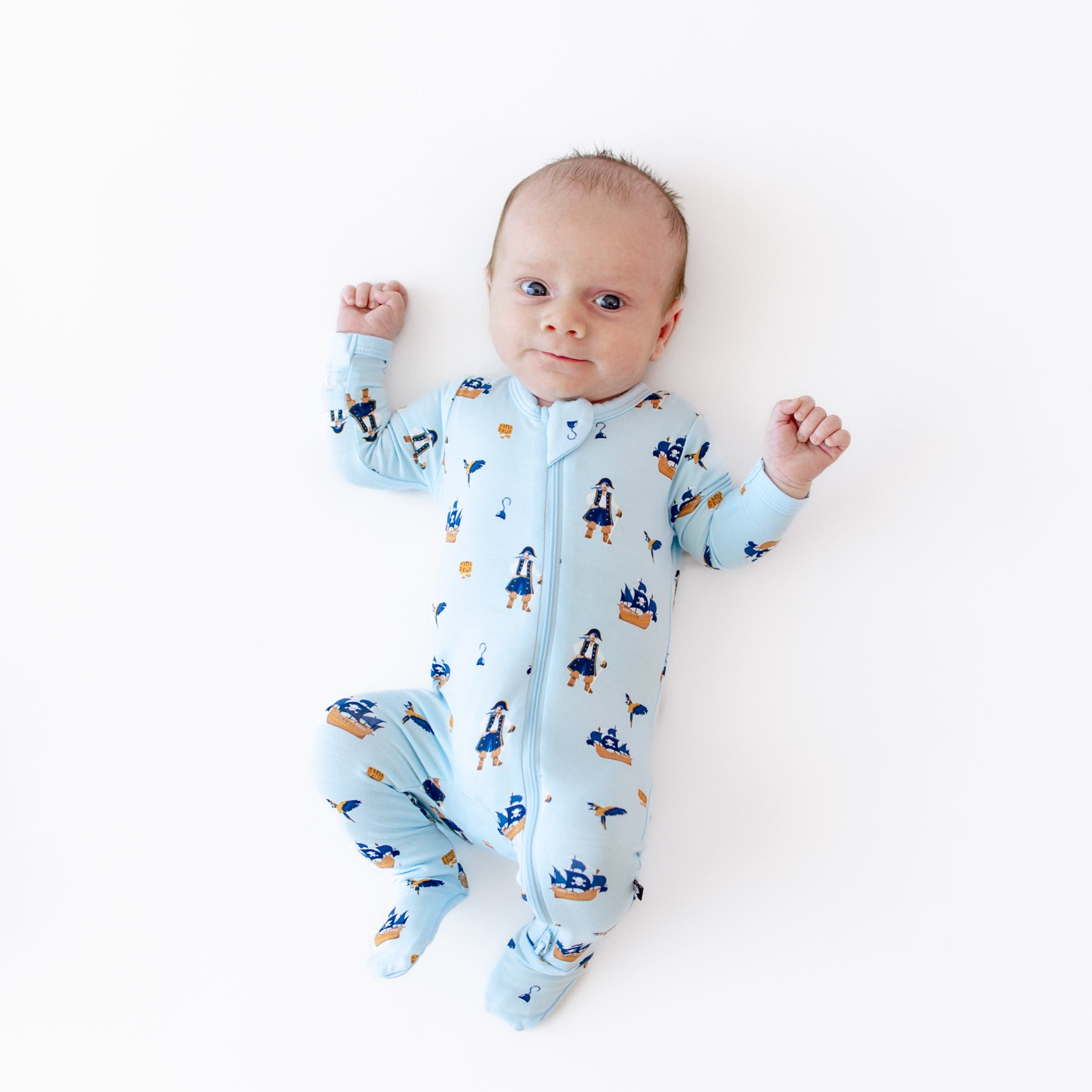 Infant wearing Kyte Baby Zippered Footie in Pirate