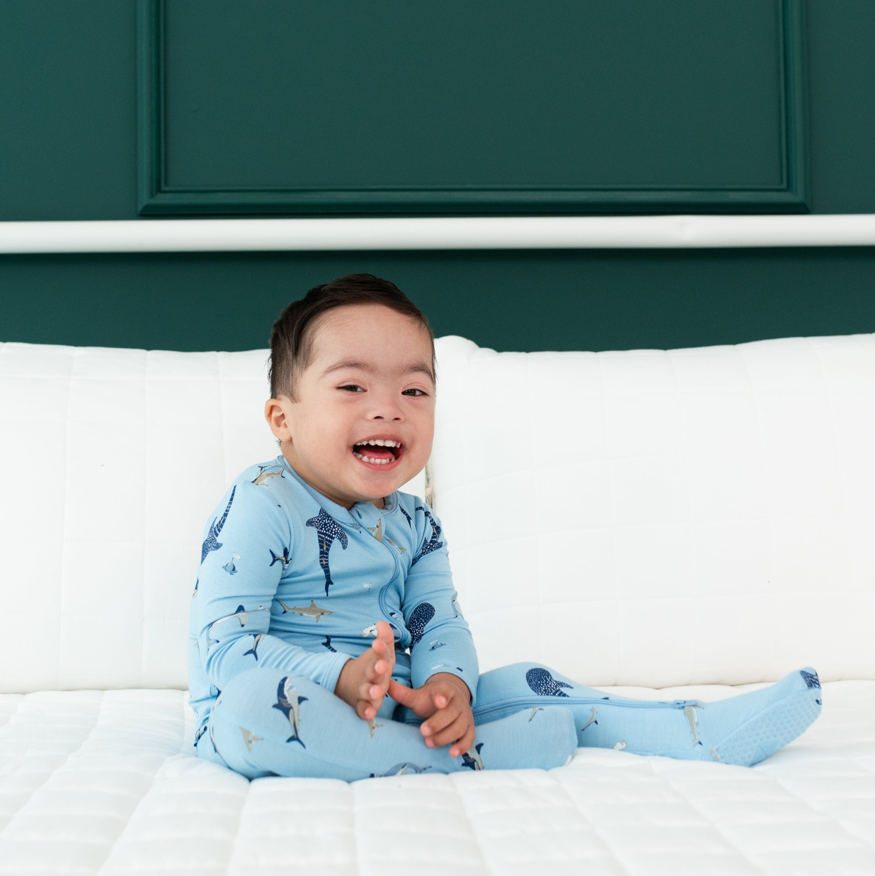 Baby wearing Kyte Baby breathable bamboo Zippered Footie in Stream Shark