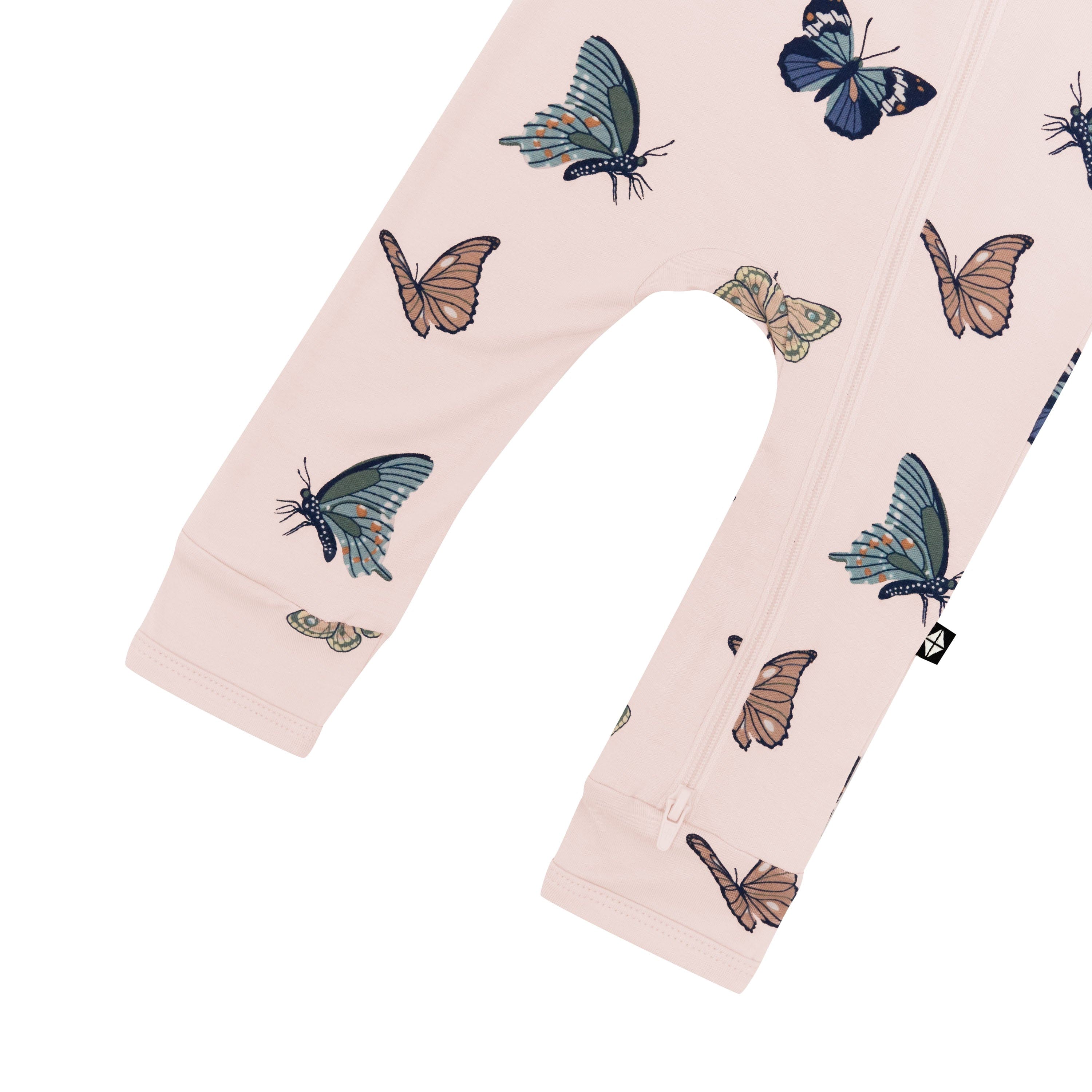 The dual zipper shown on the leg of the Zippered Romper in Blush Butterfly