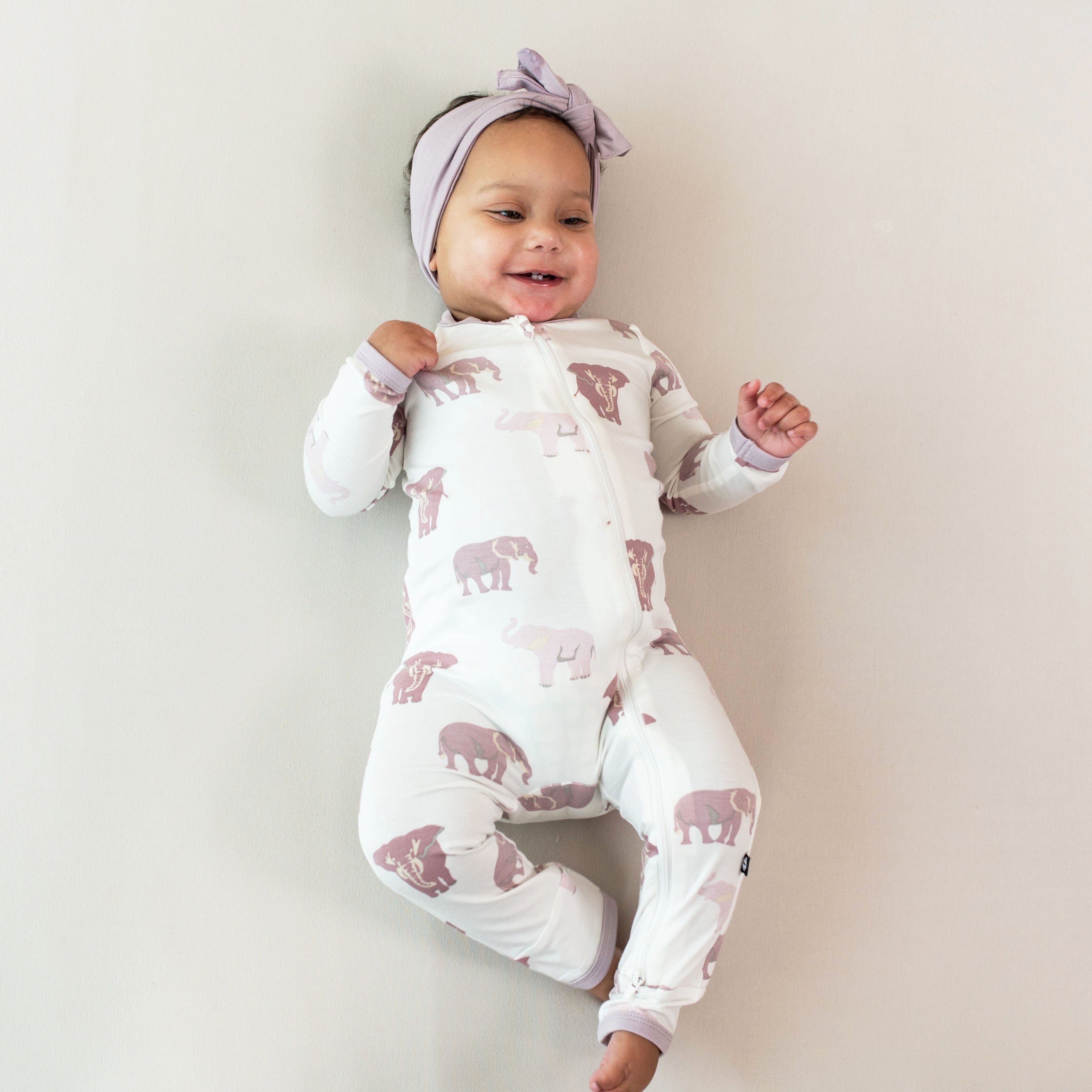 Infant wearing Kyte Baby Zippered Romper in Elephant