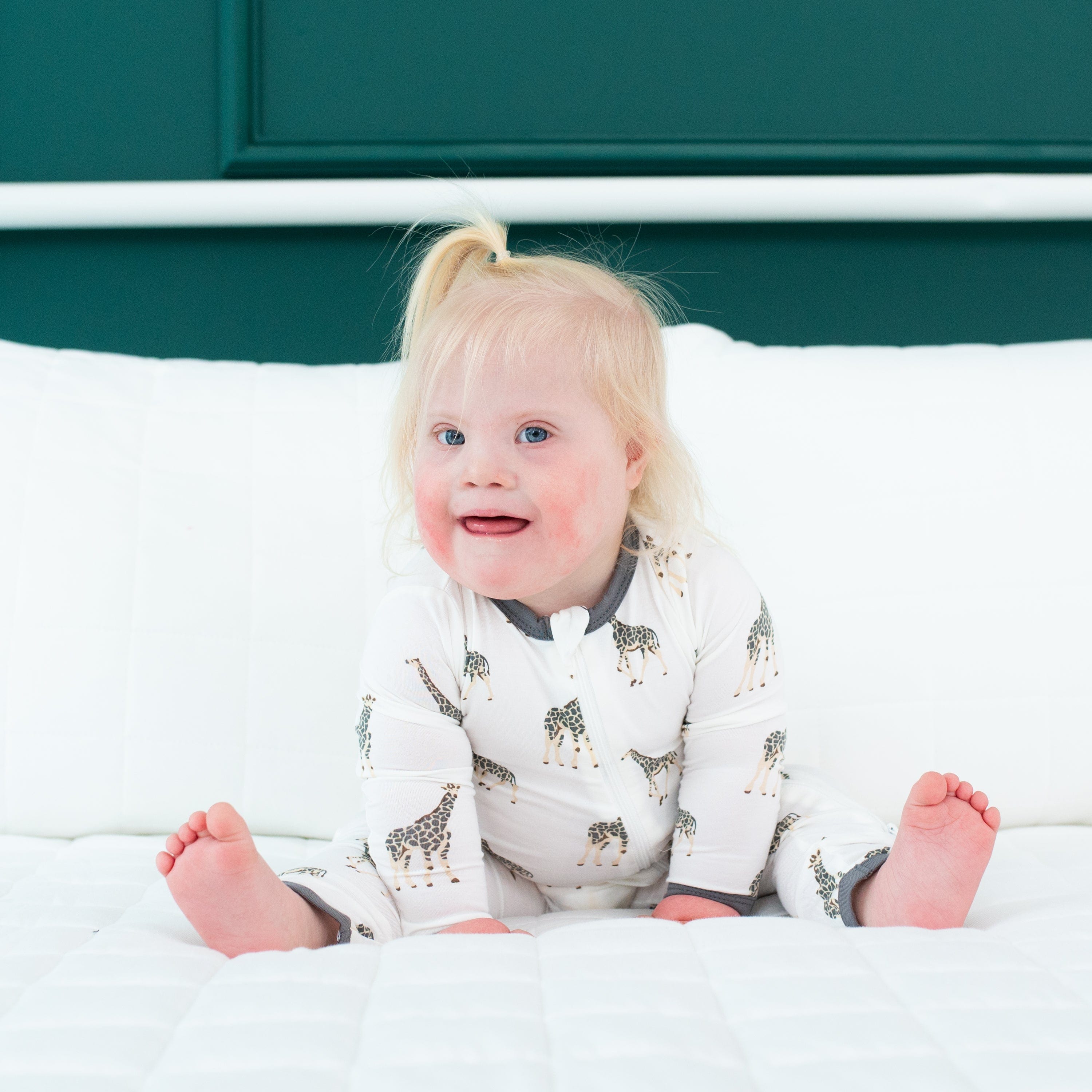 Toddler wearing Kyte Baby Zippered Romper in Giraffe