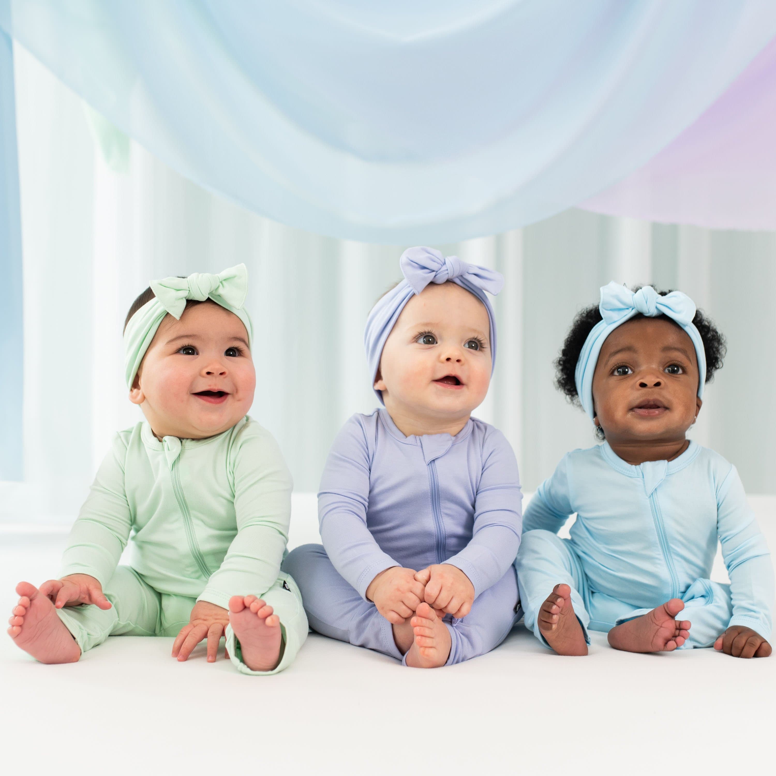 Babies wearing Kyte Baby bamboo Zippered Romper pajamas