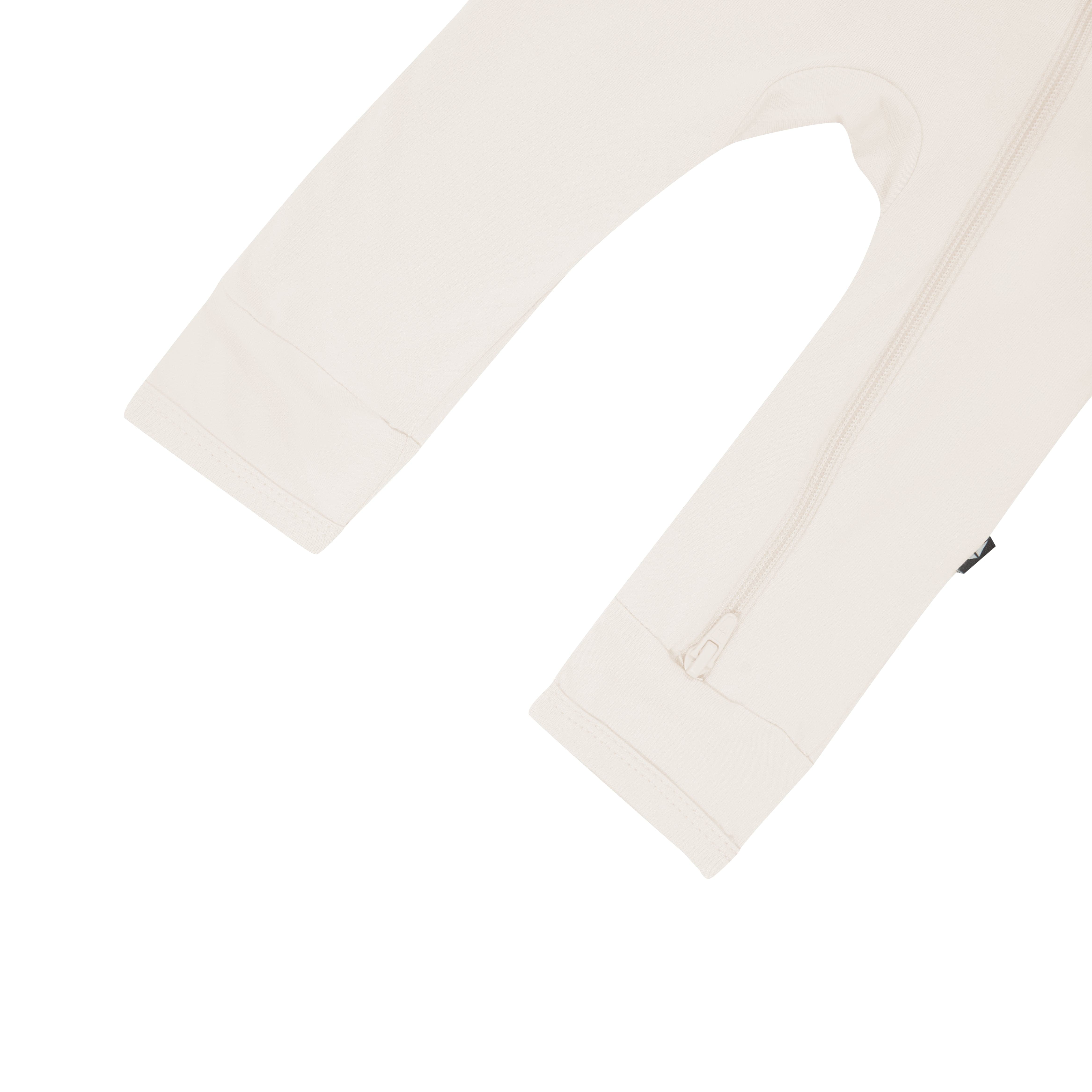 Close up of open feet on Kyte Baby Zippered Romper in Oat
