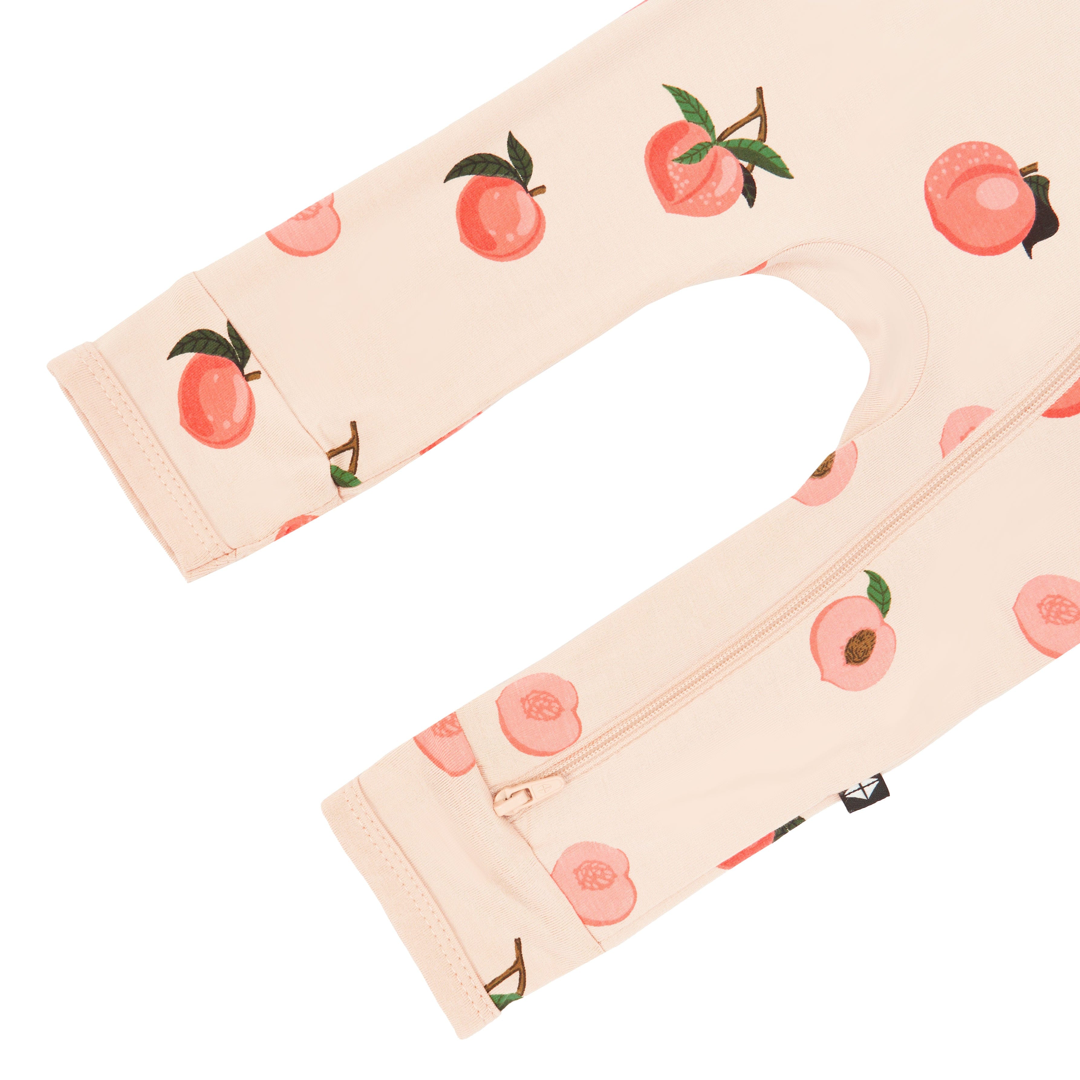 Open feet on Kyte Baby Zippered Romper in Peach