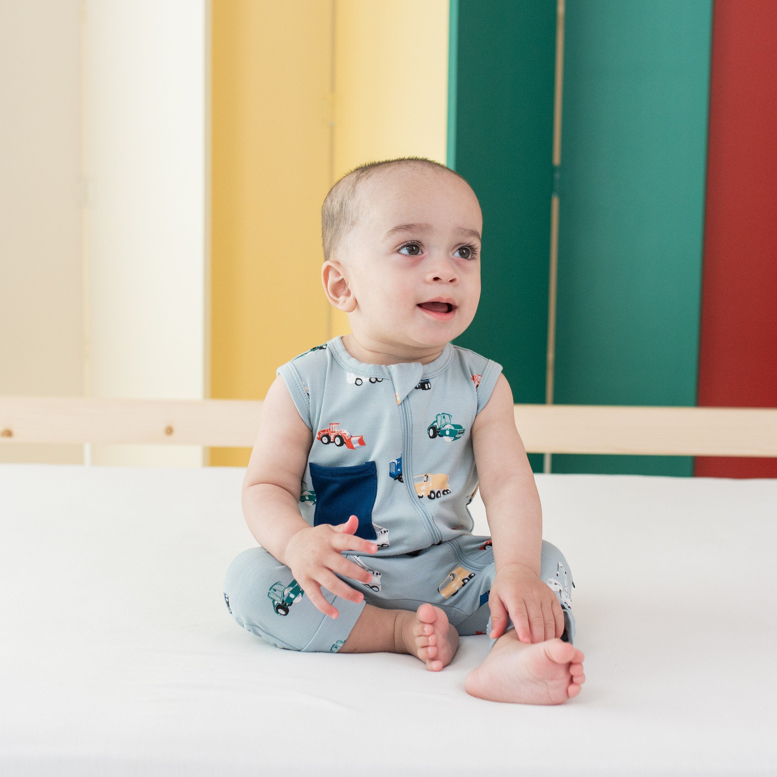 Infant wearing Kyte Baby Sleeveless Zippered Romper in Construction