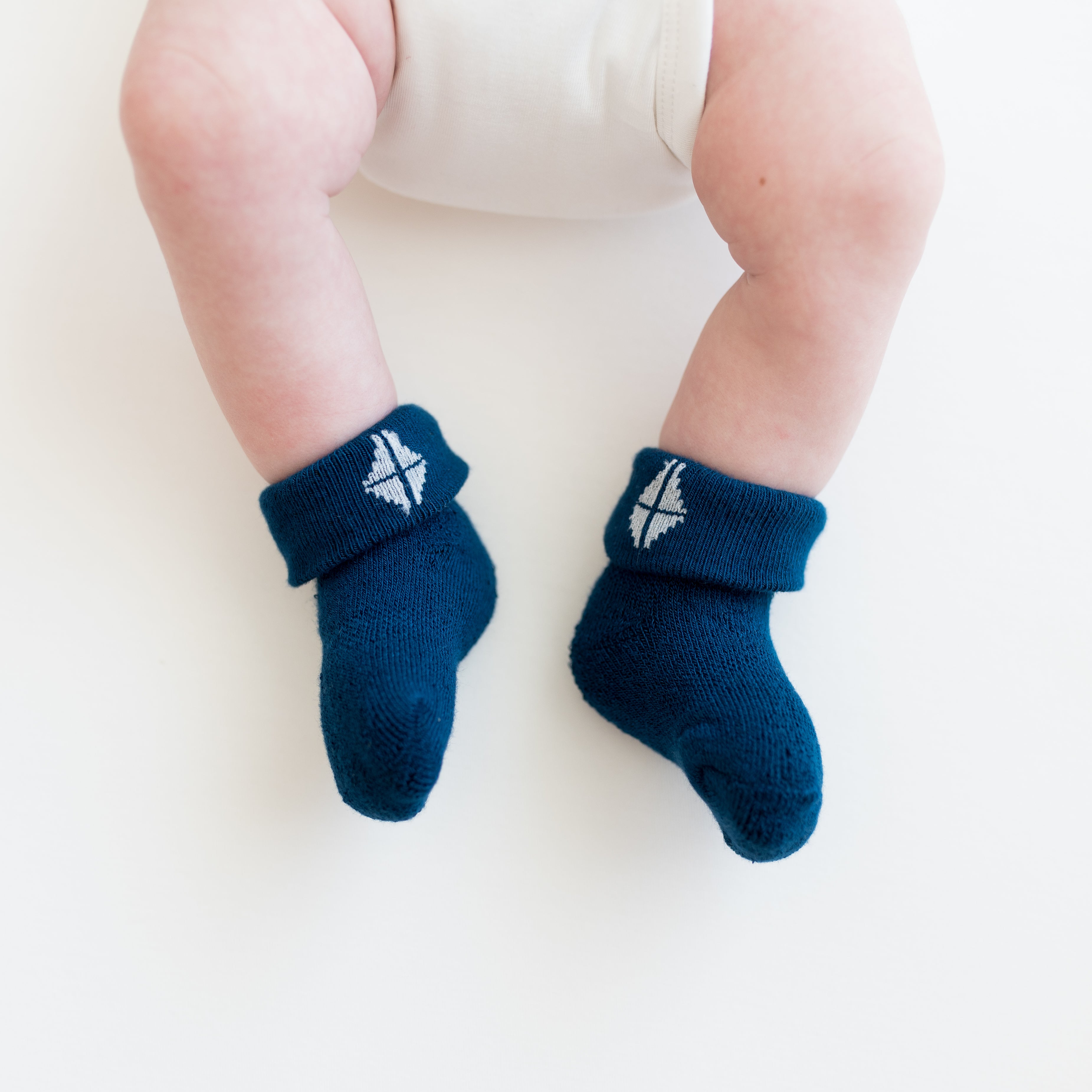 Infant wearing Tahoe blue infant socks