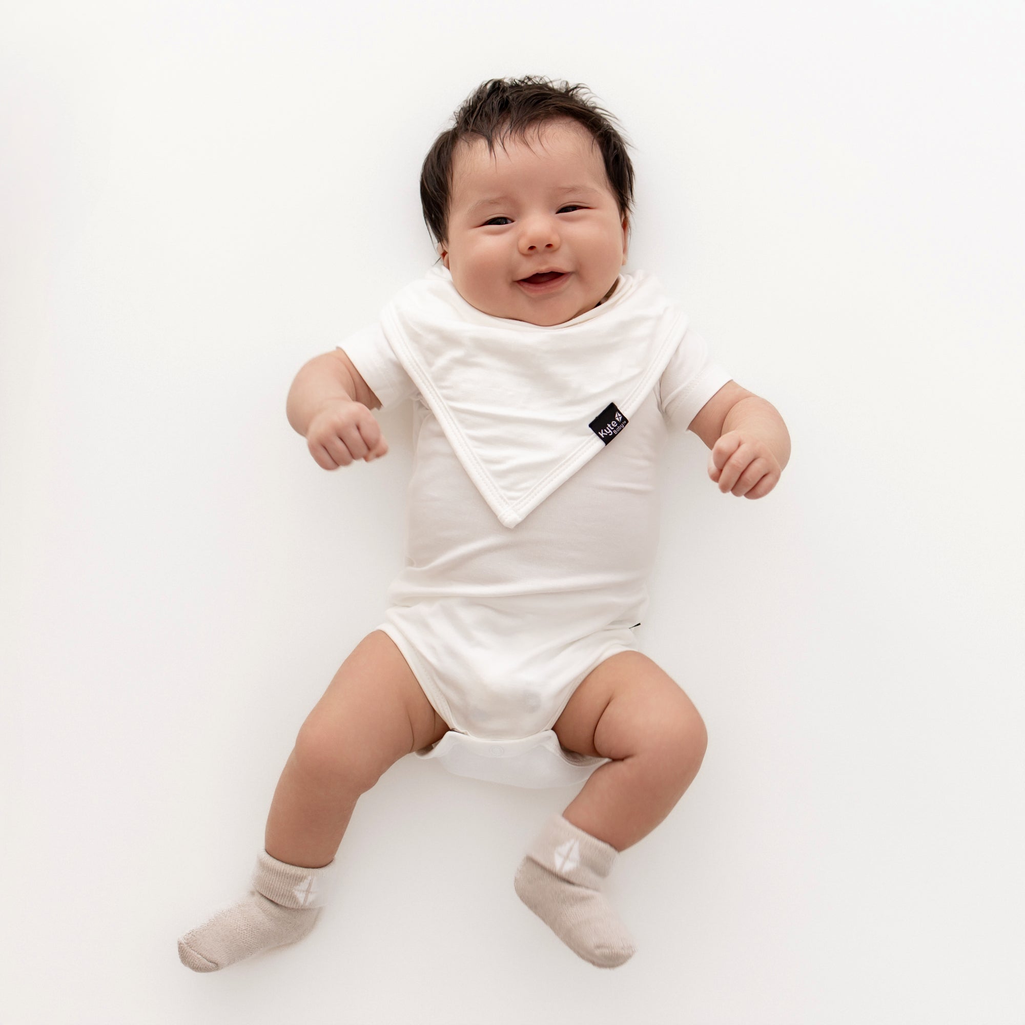 Baby wearing neutral colors with plush infant socks