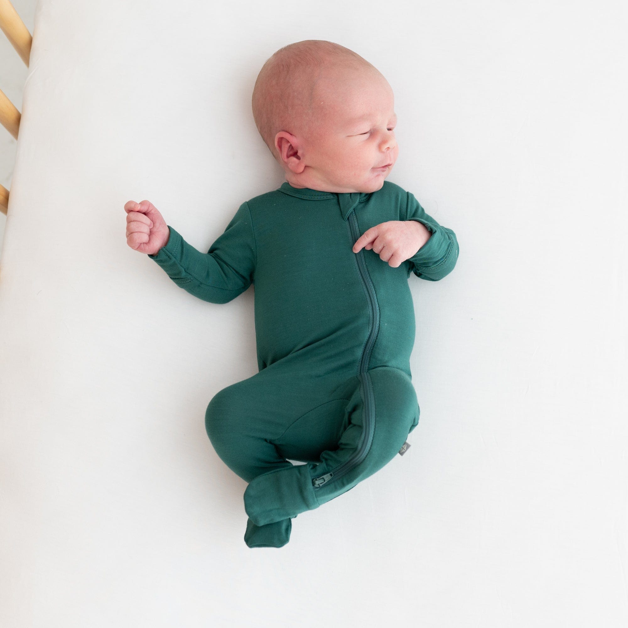 Preemie baby in zippered footie in emerald
