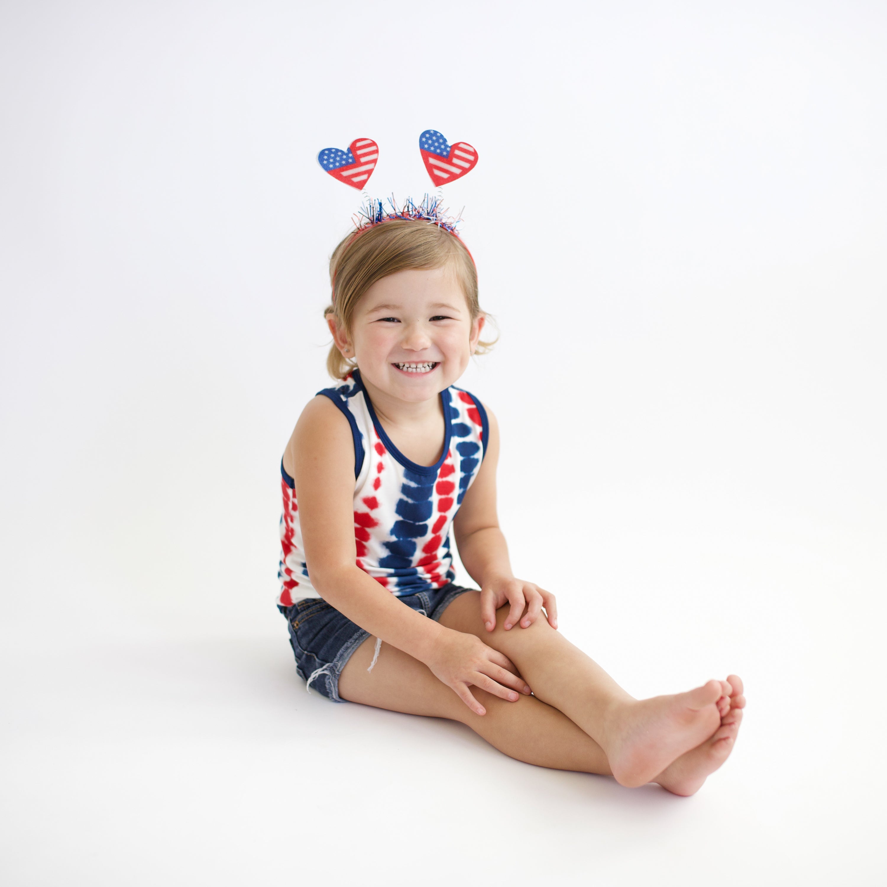 Toddler wearing Toddler Tank Top in Liberty Rip Tide and festive headband