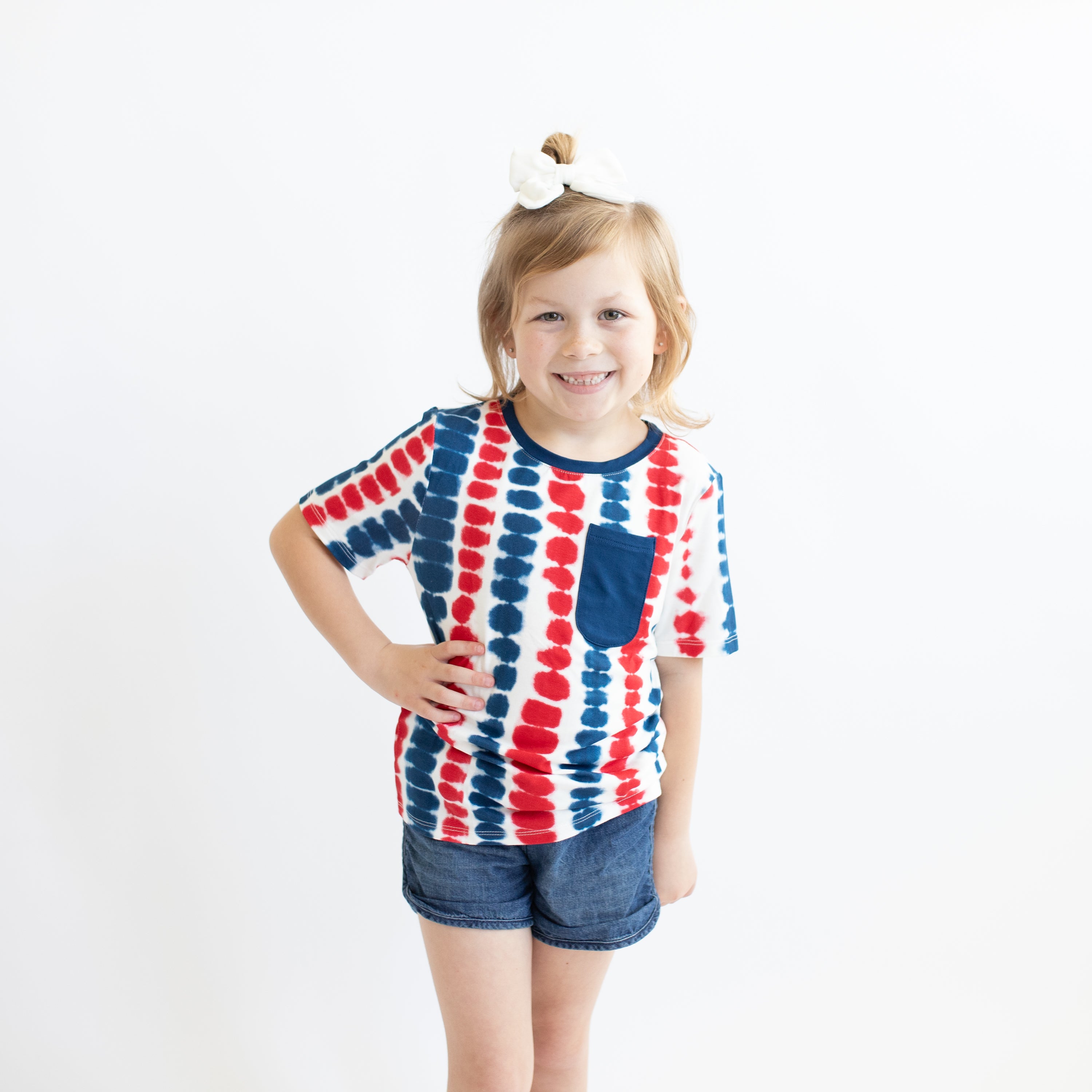 Child wearing Toddler Crew Neck Tee in Liberty Rip Tide and jean shorts