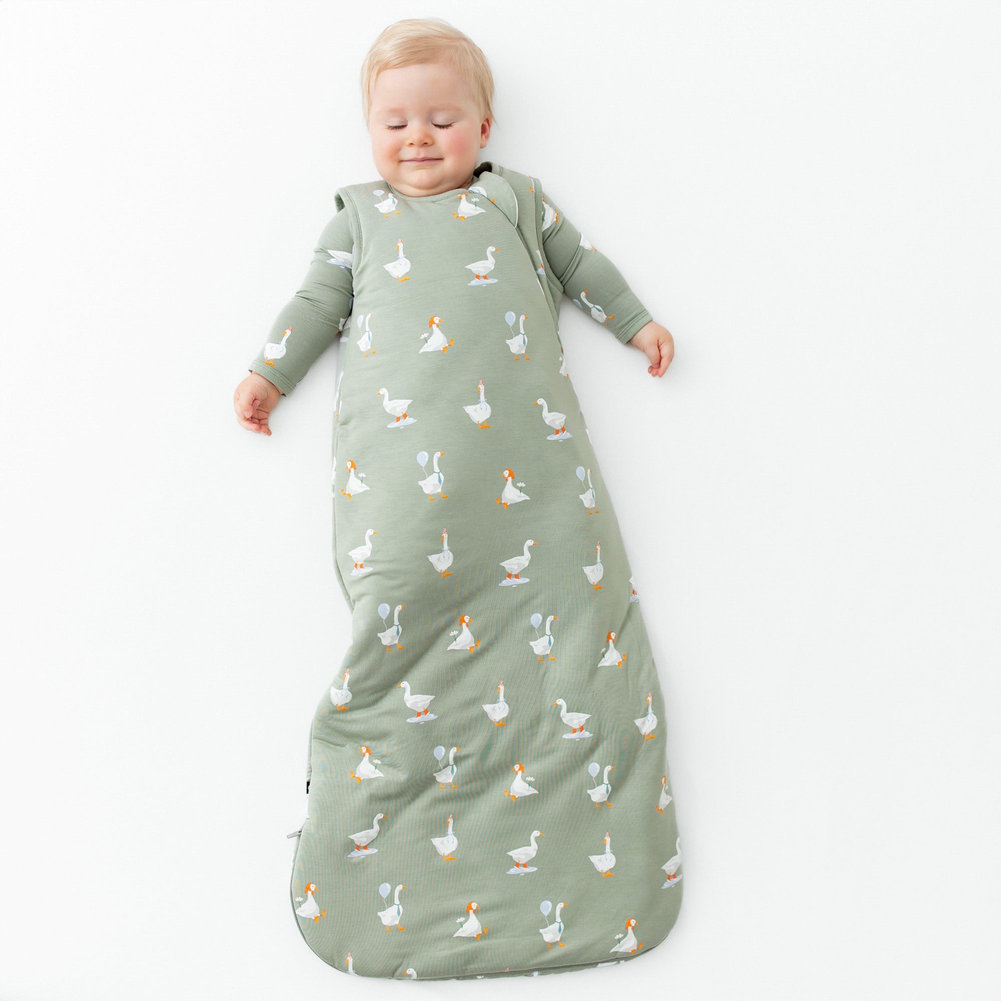 Child wearing green Sleep Bag in Silly Goose 2.5 TOG with matching bamboo pajamas
