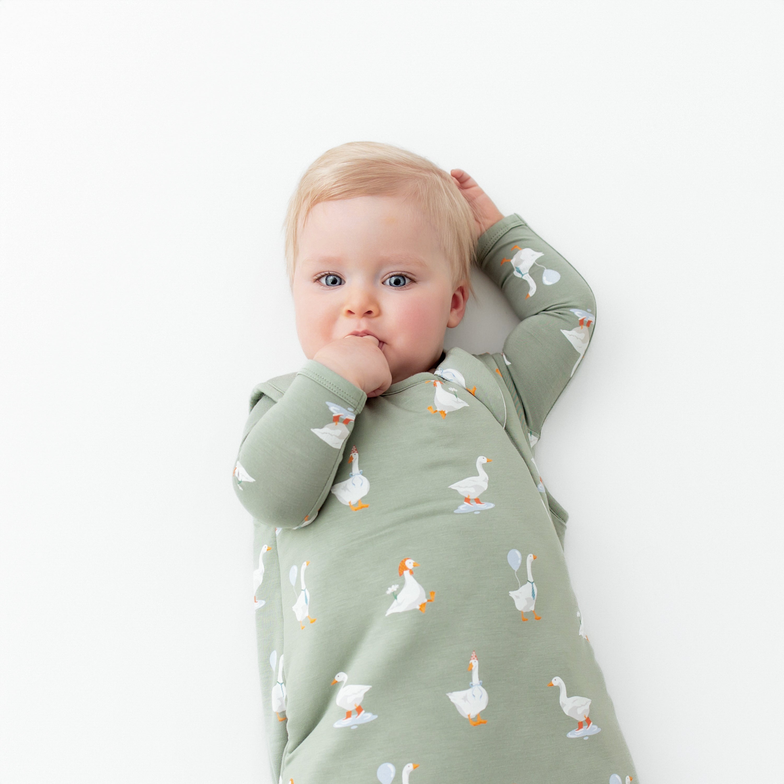 Infant wearing bamboo Sleep Bag in Silly Goose 2.5 TOG over matching kids pajamas