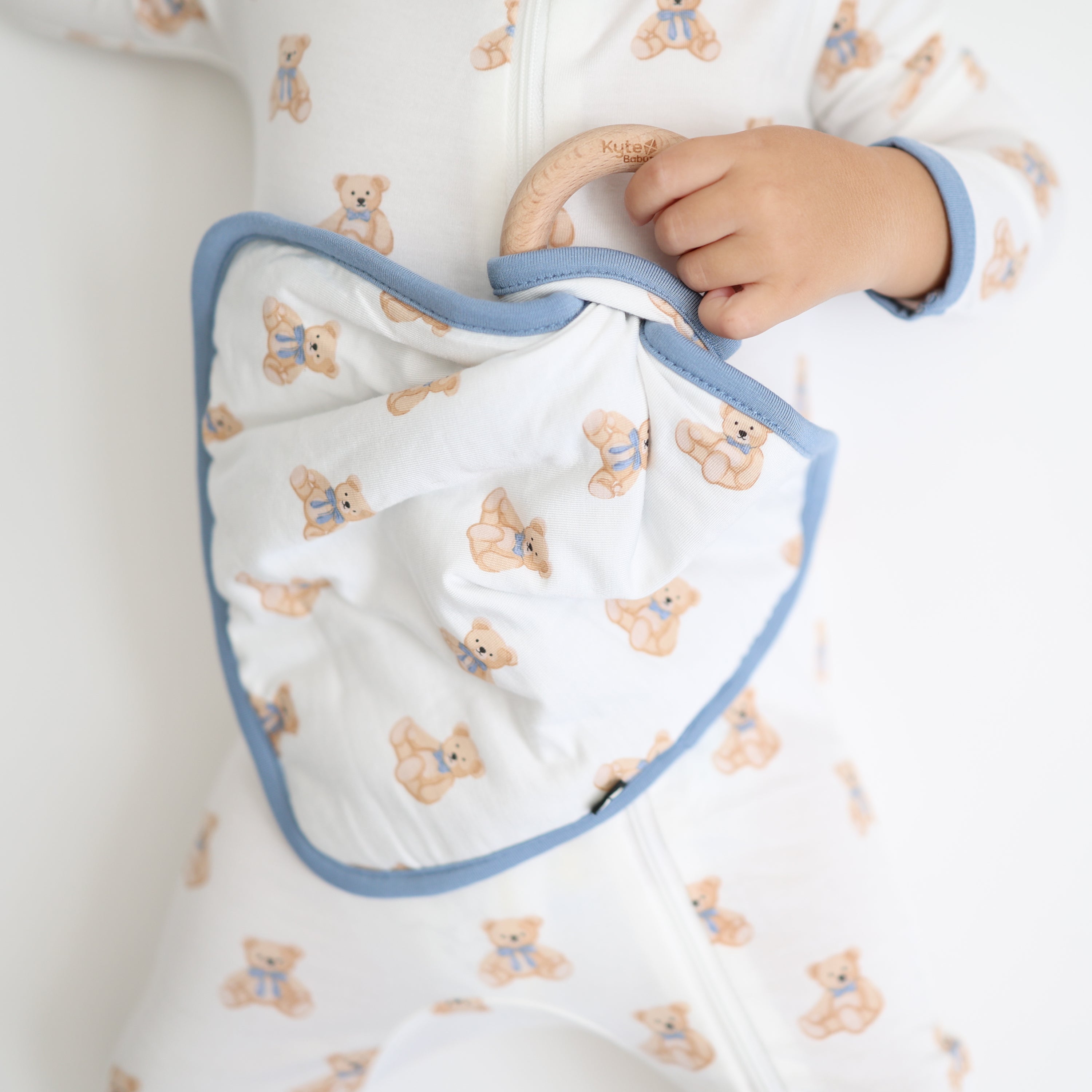 Lovey in Teddy Bear with Removable Wooden Teething Ring shown being held by toddler