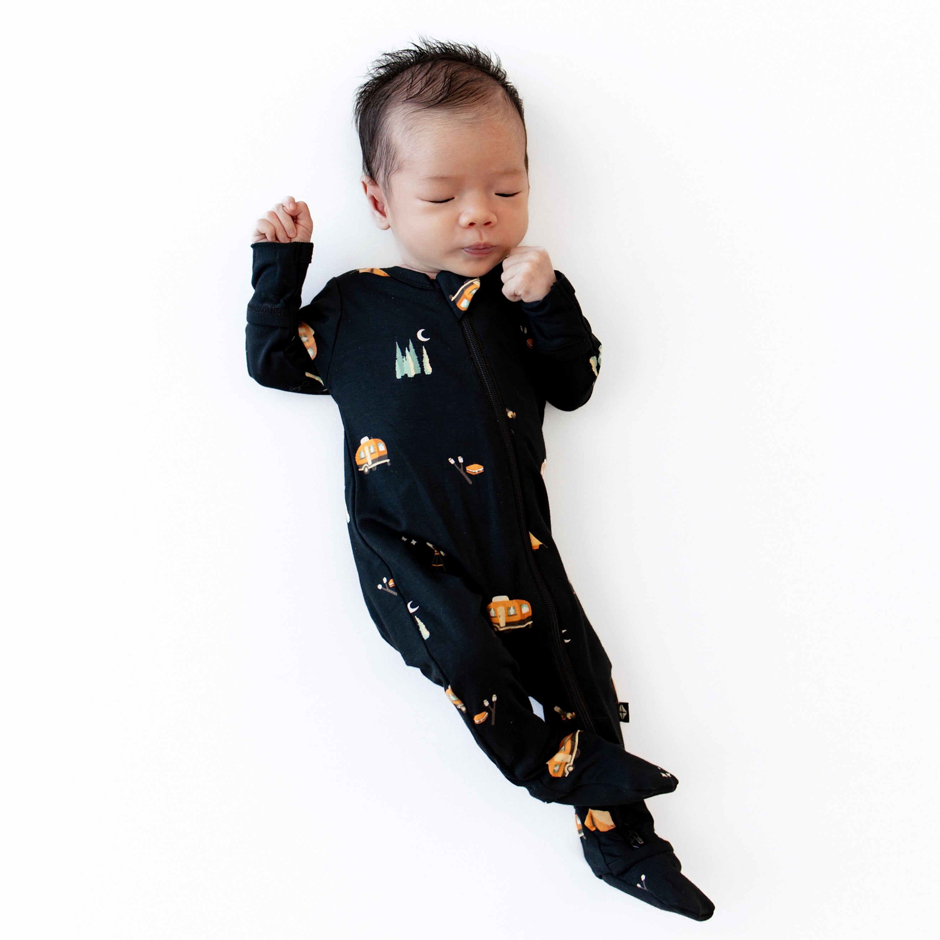 Newborn wearing the Zippered Footie in Under the Stars