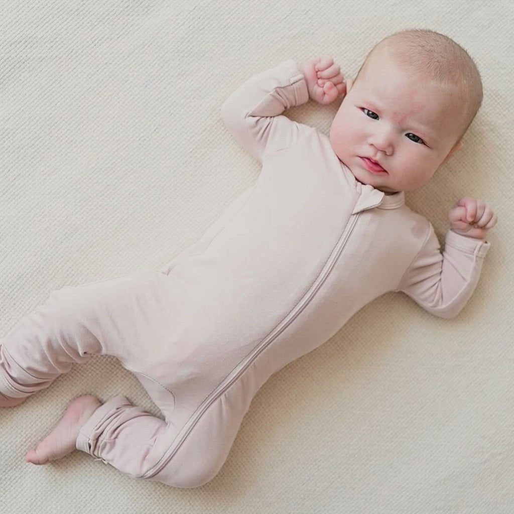 Video of newborn wearing Kyte Baby Zippered Romper in Blush