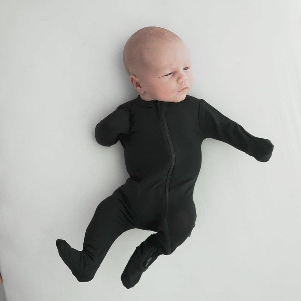 Video of baby wearing Kyte Baby Zippered Footie in Midnight