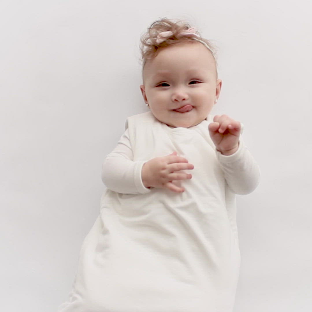 Video of baby wearing Kyte Baby Sleep Bag 1.0 in Cloud White