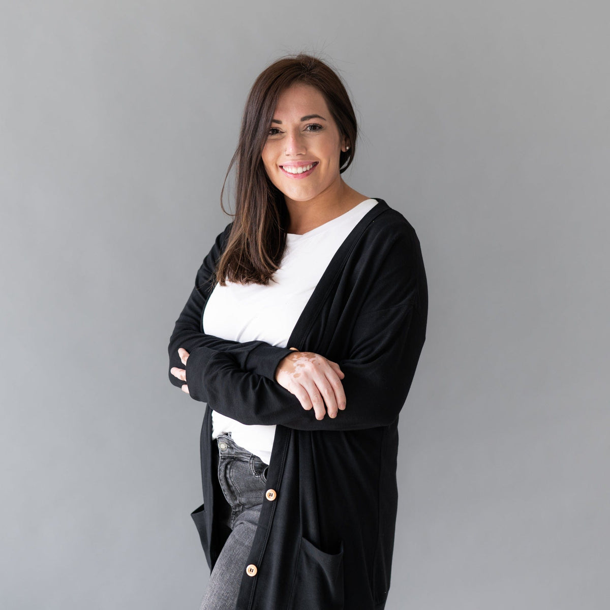 Woman wearing Kyte Baby Adult Cardigan in Midnight Black