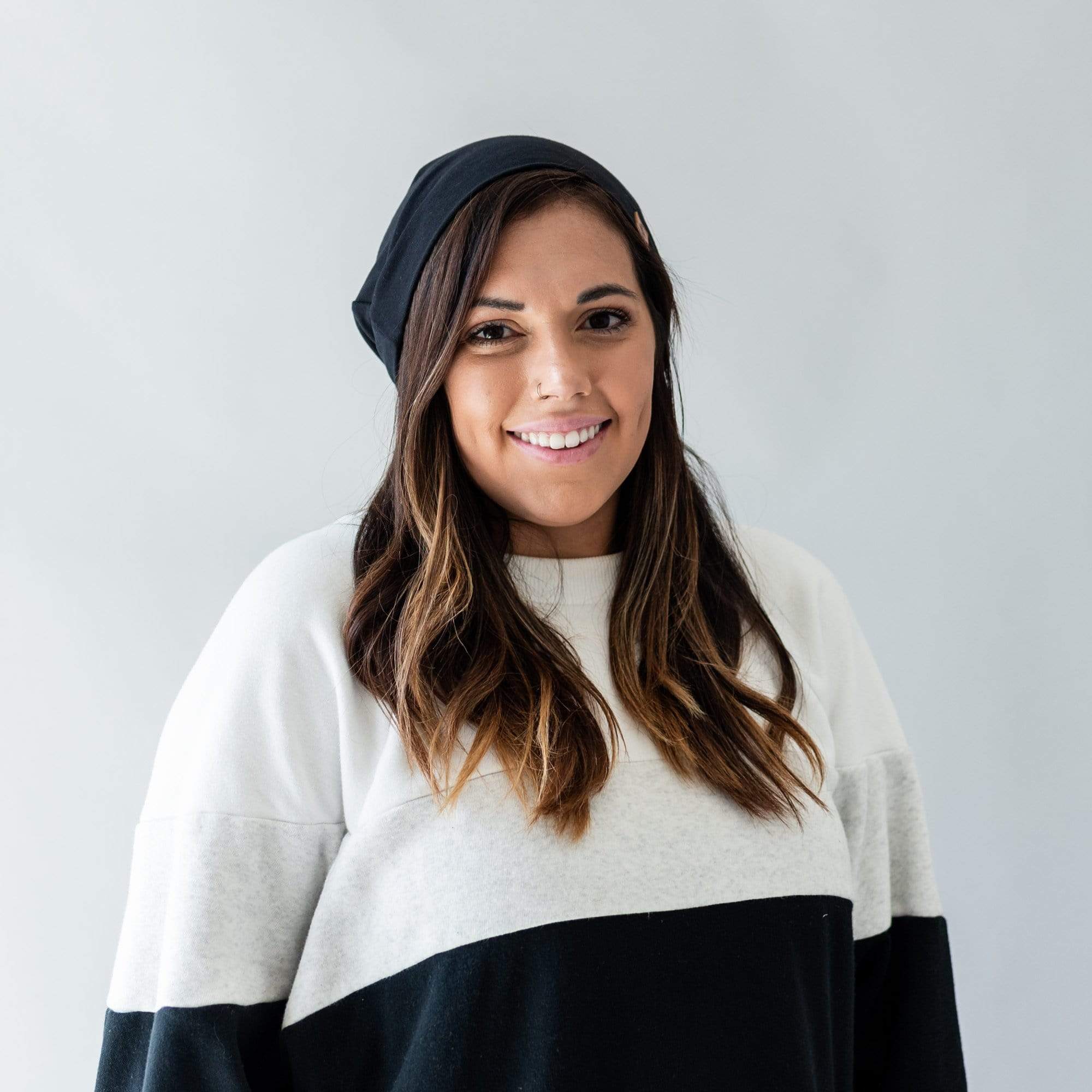 Woman wearing Kyte Baby Adult Beanie in Midnight