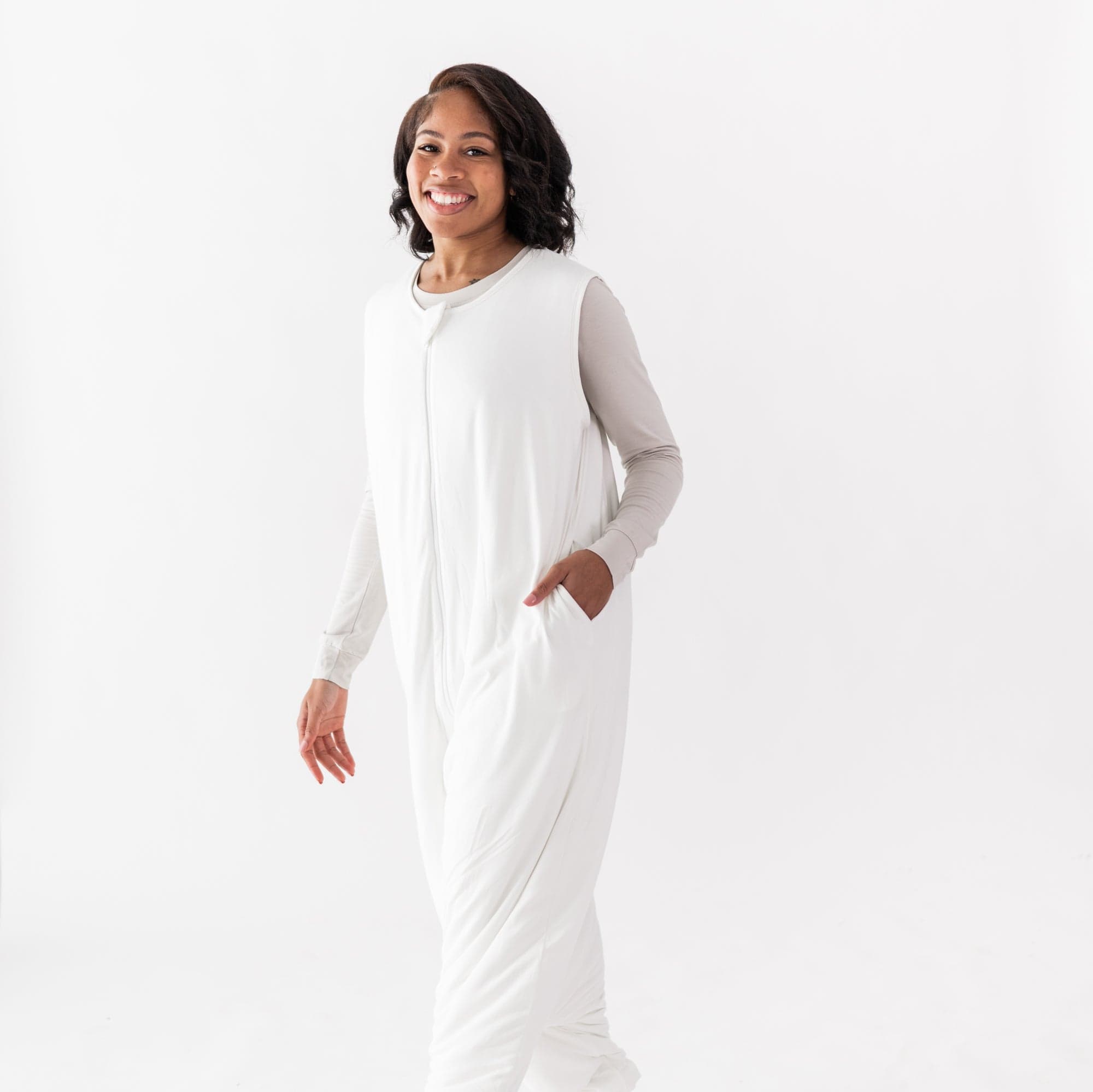 Woman wearing Kyte Baby Adult Sleep Bag Walker wearable blanket in Cloud White