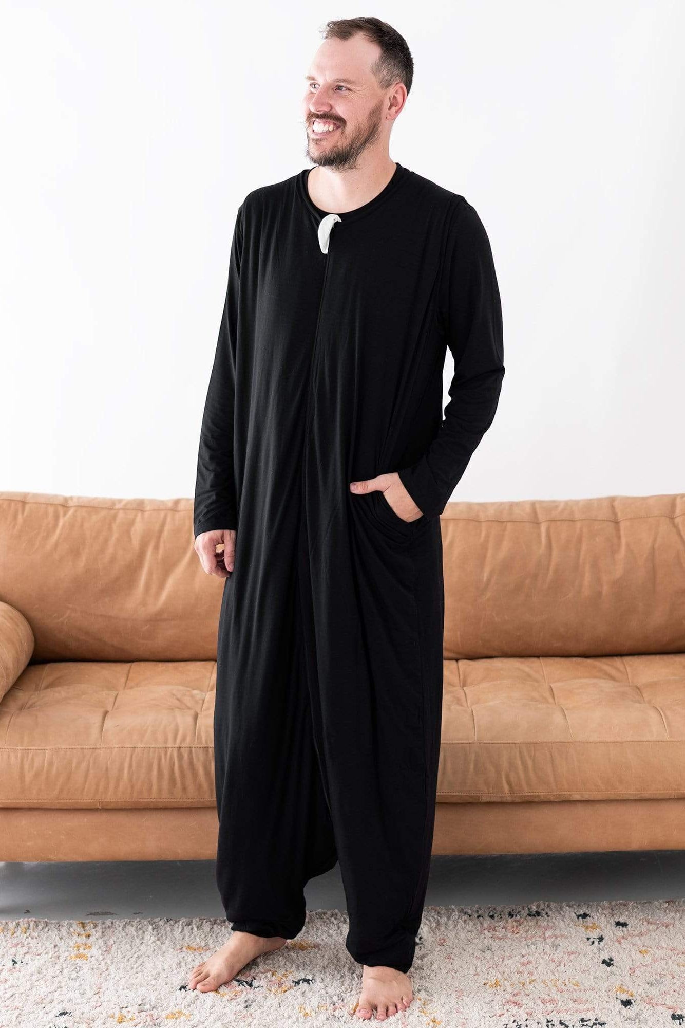 Man wearing Kyte Baby Adult Sleep Bag Walker in Midnight