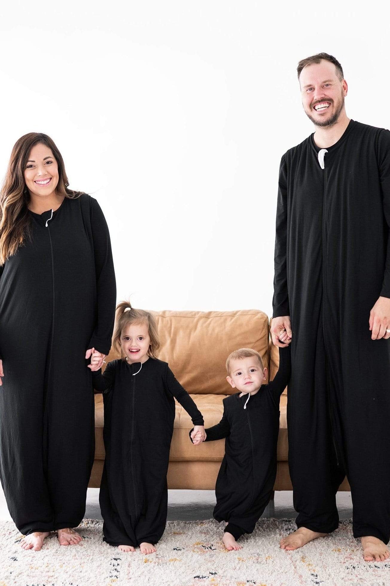 Family in matching Kyte Baby Sleep Bag Walker pajamas in Midnight