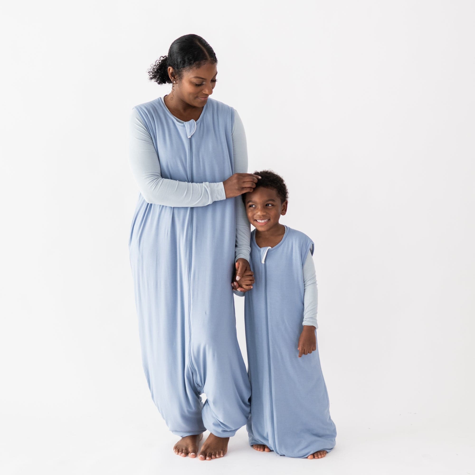Family in matching Kyte Baby Sleep Bag Walker pajamas in Slate