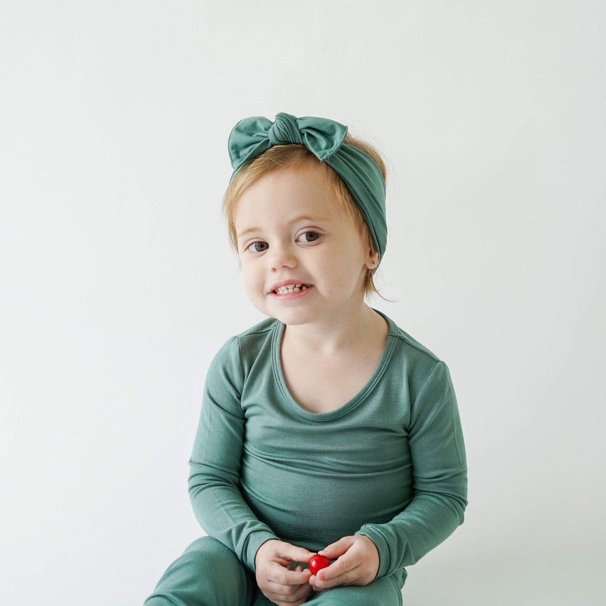 Toddler modeling Bow in Pine