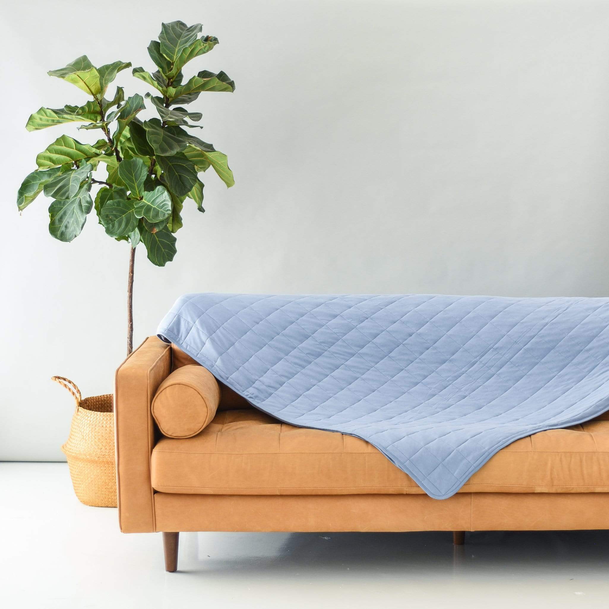 Couch with Kyte Baby Adult Quilted bamboo Blanket in Slate TOG 2.5