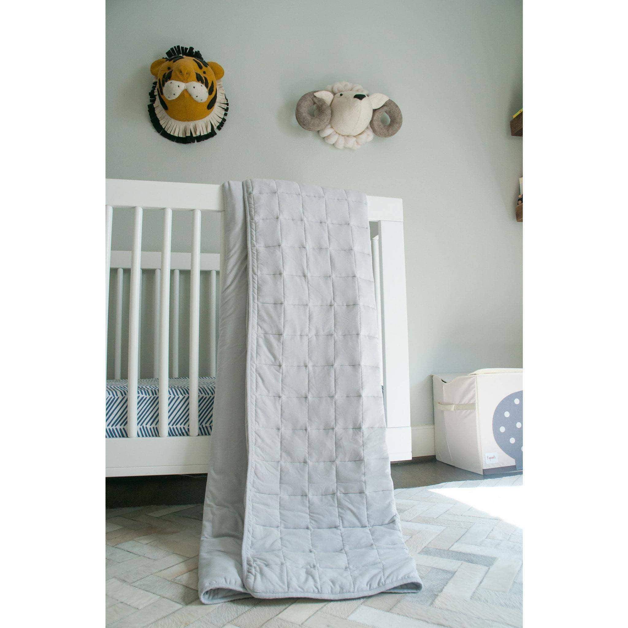 Kyte Baby Toddler Blanket 2.5 TOG draped over a white crib