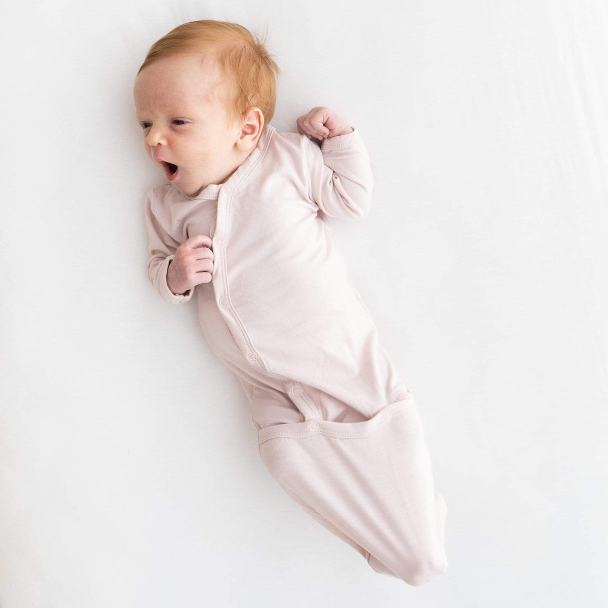 Infant wearing Kyte Baby Bundler in Blush