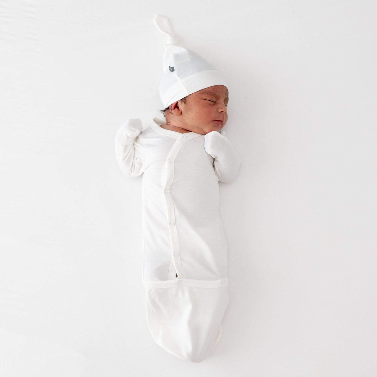 Newborn wearing Kyte Baby Bundler in Cloud white