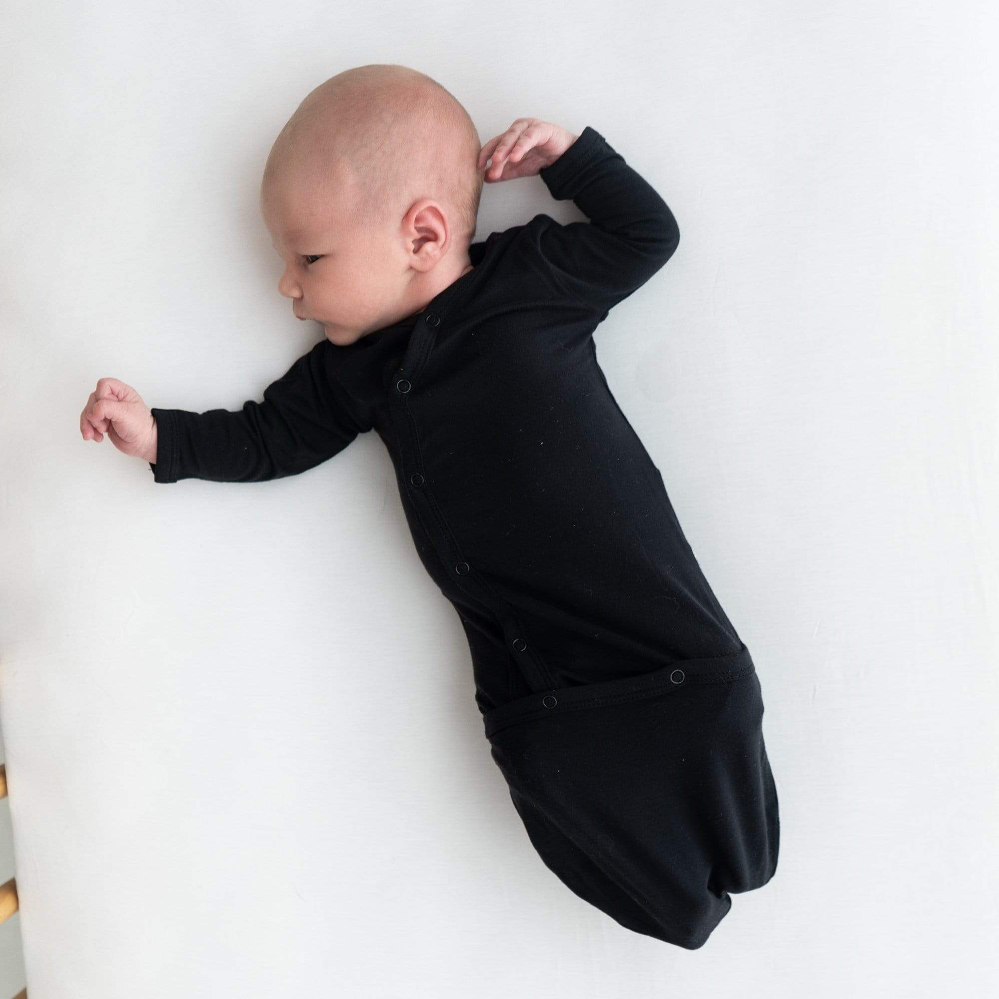 Newborn wearing Kyte Baby Bundler in Midnight