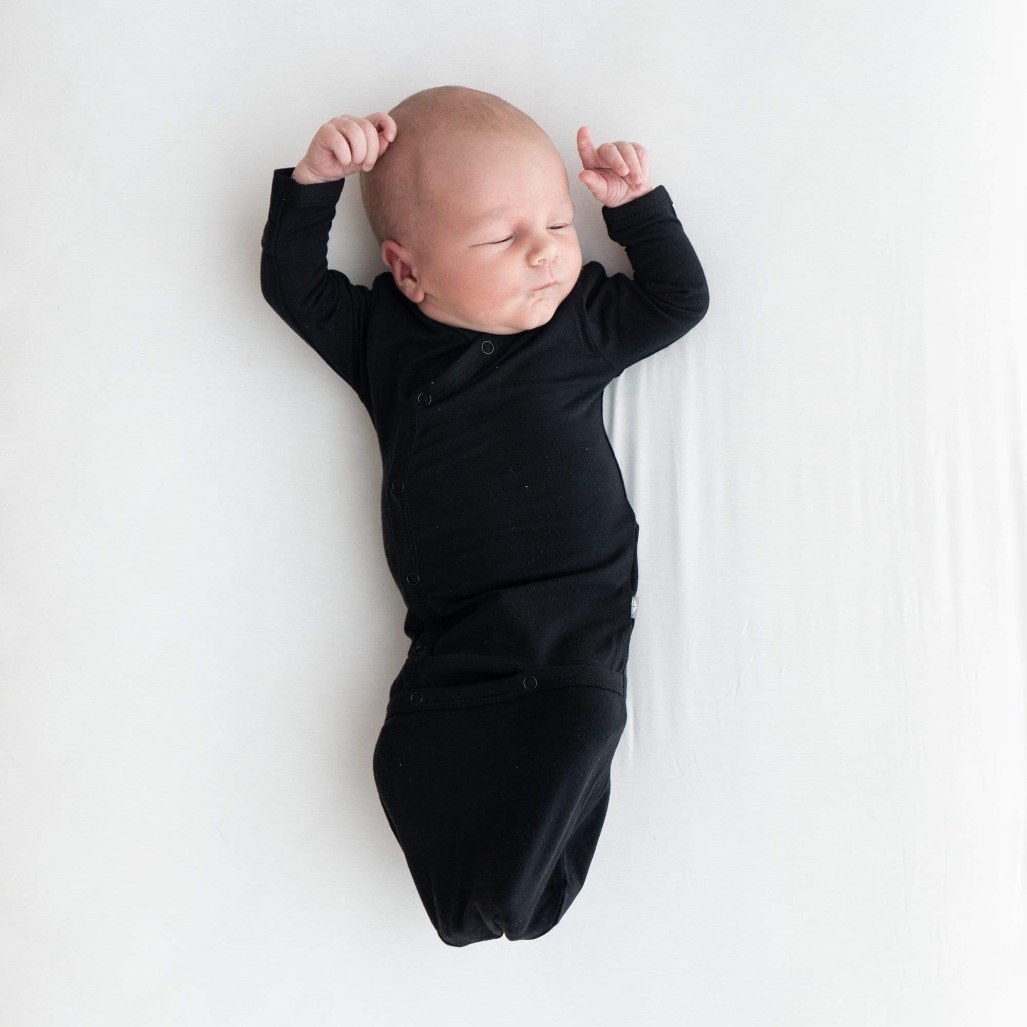 Infant wearing Kyte Baby Snap Bundler in Midnight