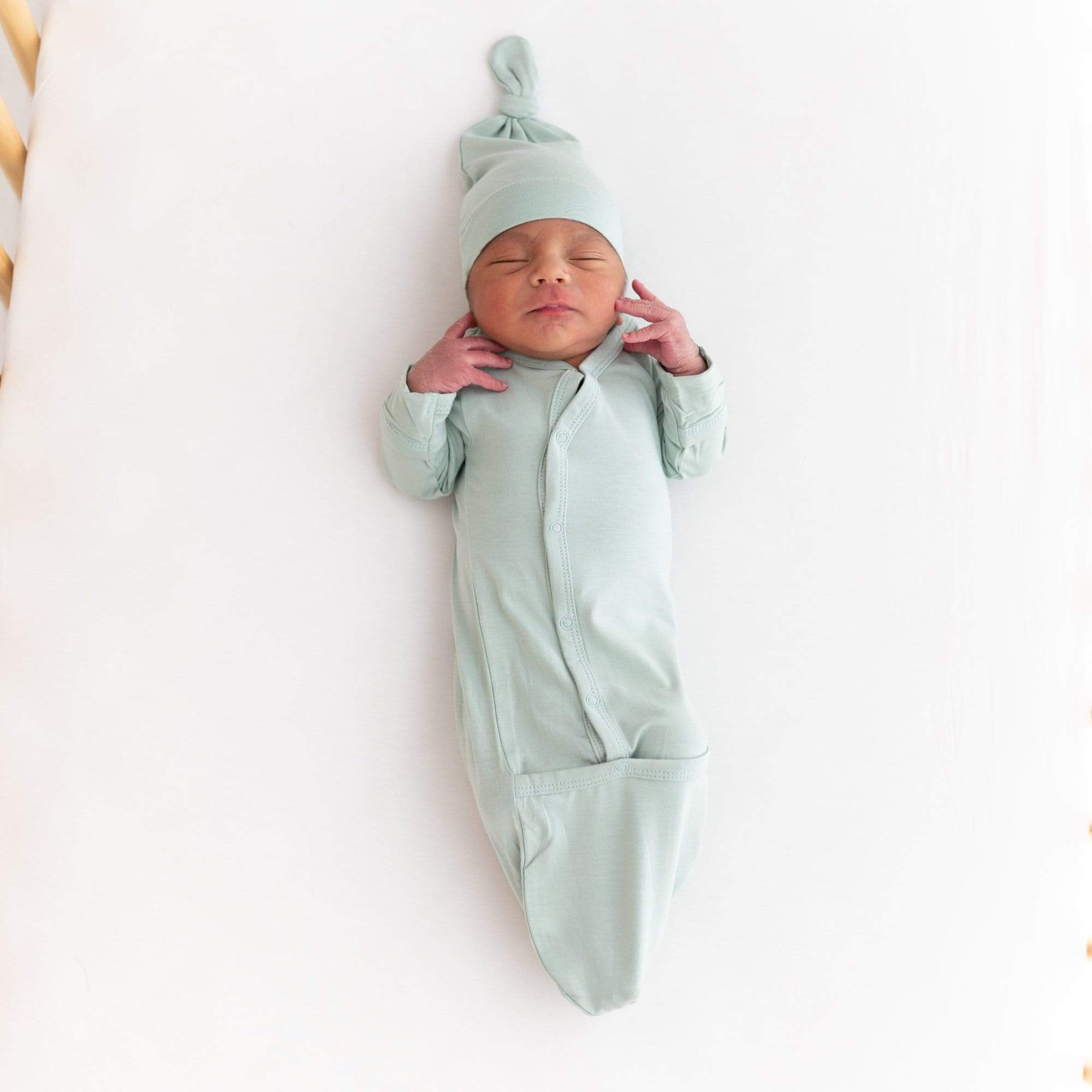 Sleeping newborn wearing Kyte Baby Bundler in Sage