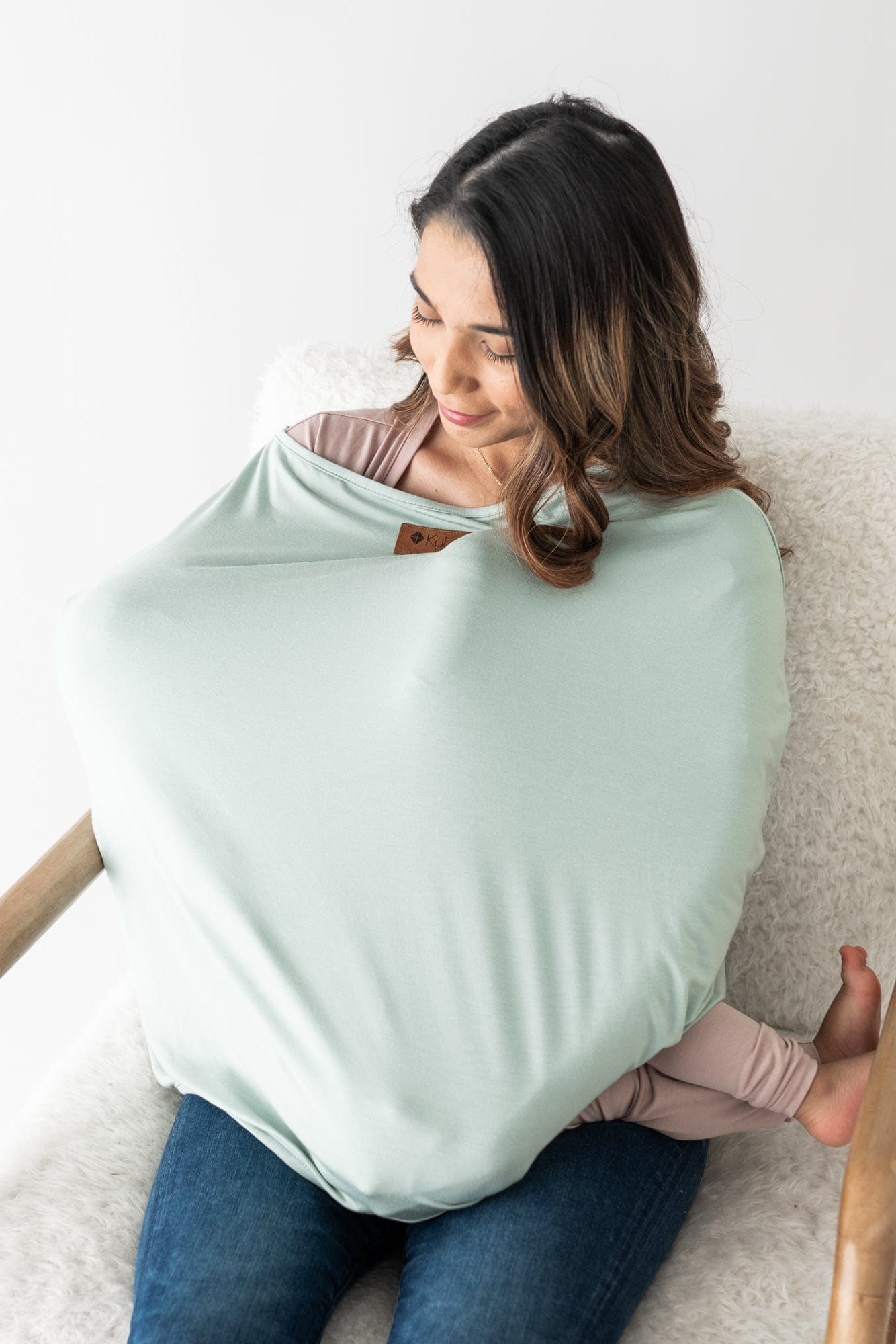 Mom nursing baby using Kyte Baby 3-in-1 bamboo Cover in Sage