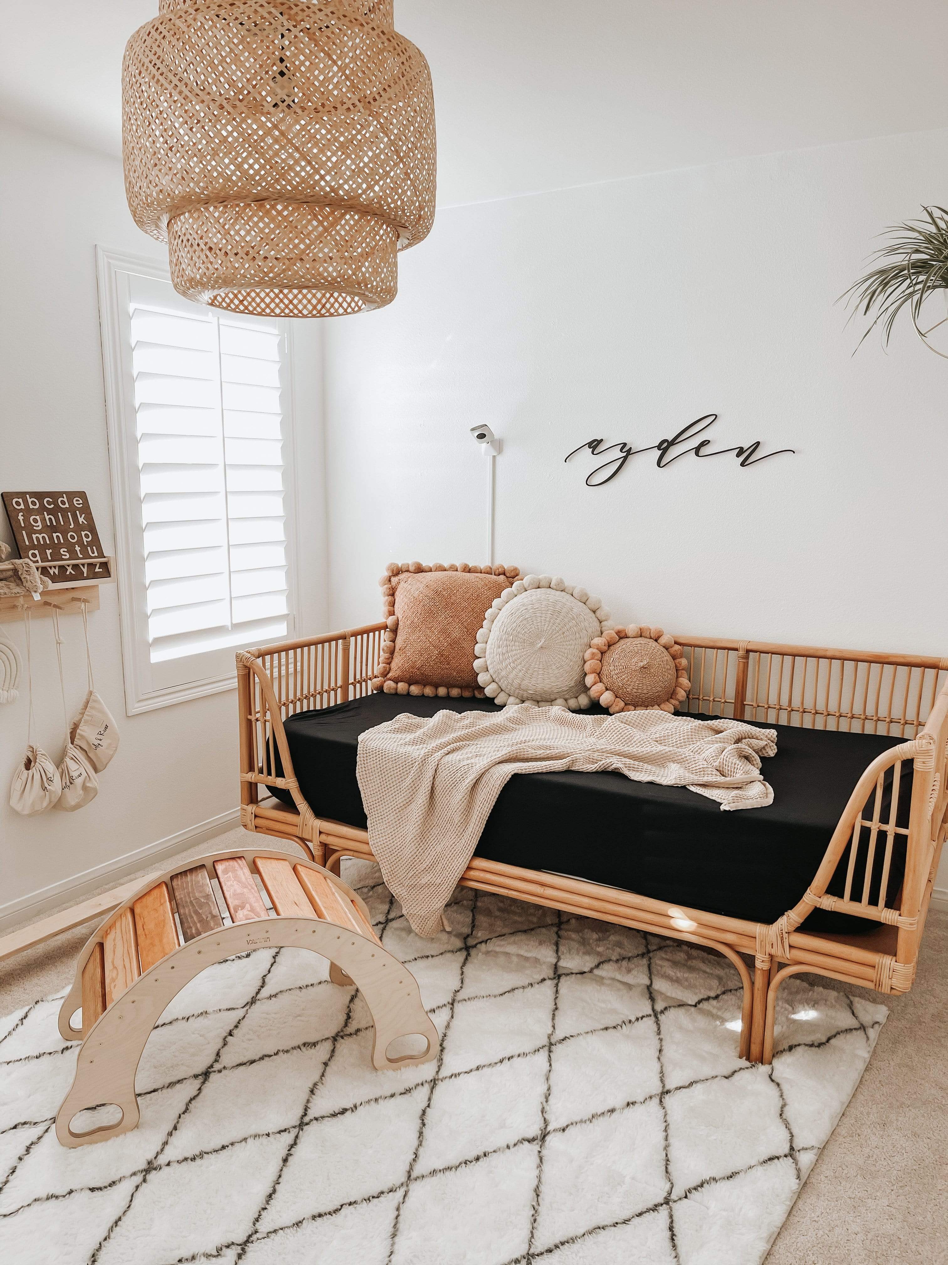 Kyte Baby bamboo fitted Twin Sheet in Midnight on day bed