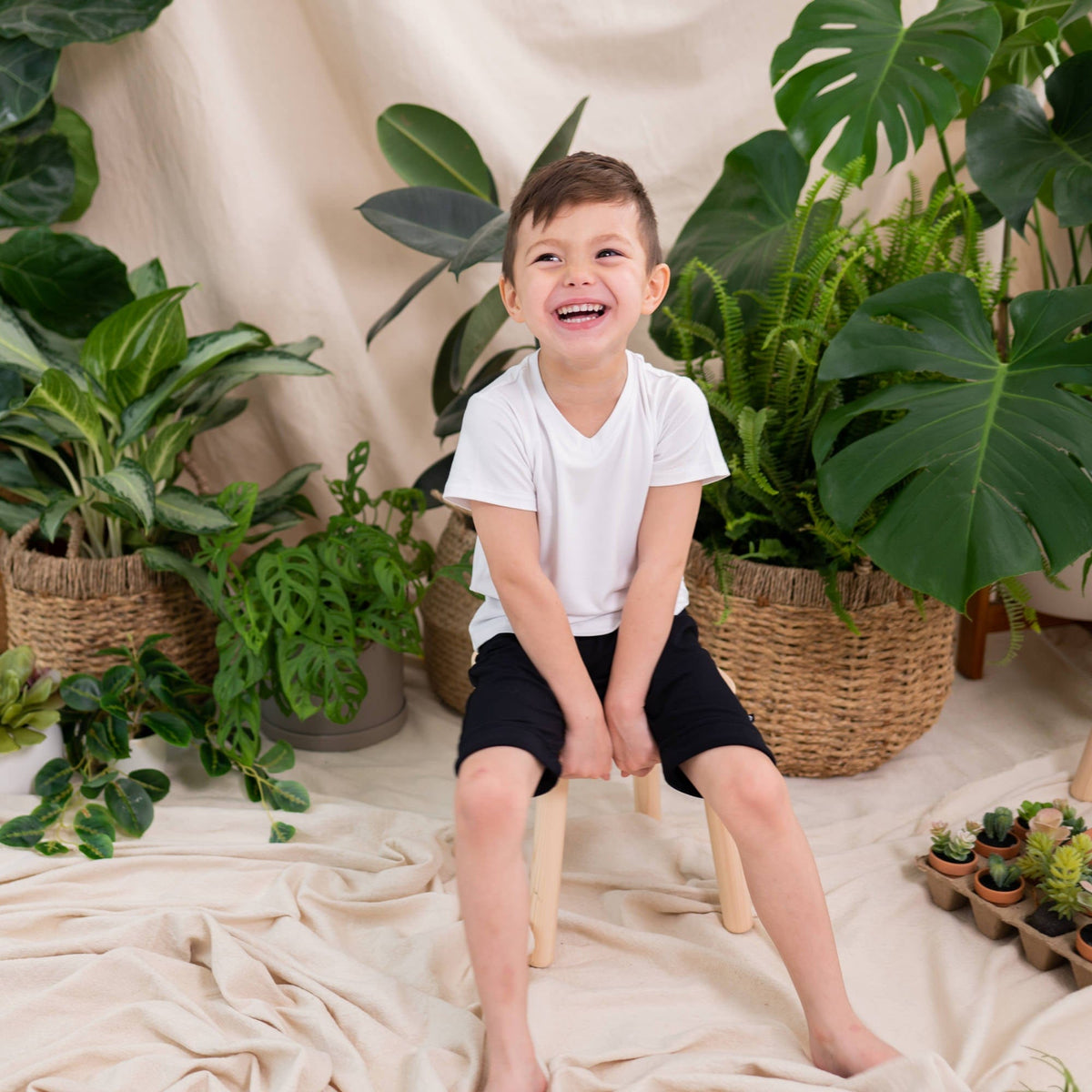 Boy wearing Kyte Baby Harem Shorts in Midnight