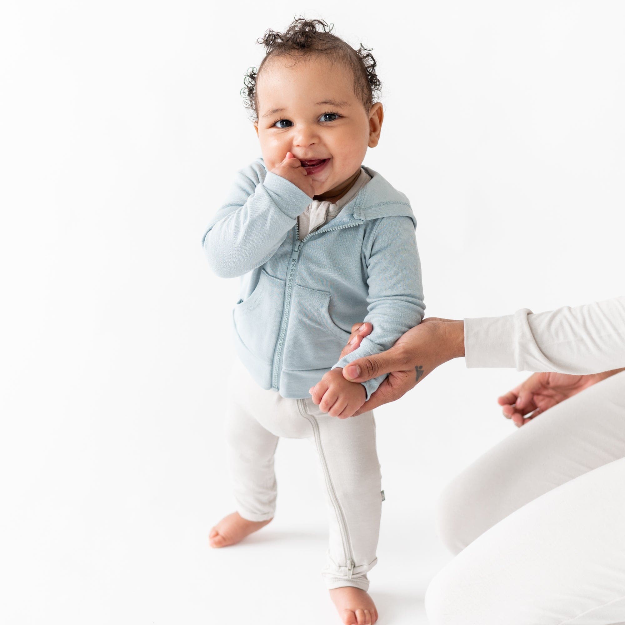 Infant wearing Kyte Baby Bamboo Jersey Hooded Jacket in Fog