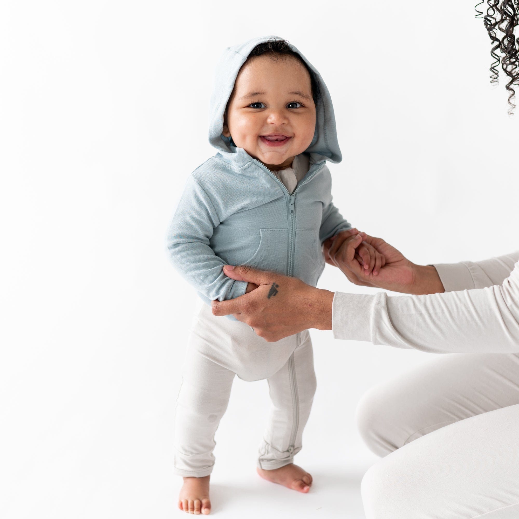 Infant wearing Kyte Baby Bamboo Jersey Jacket with Hood in Fog