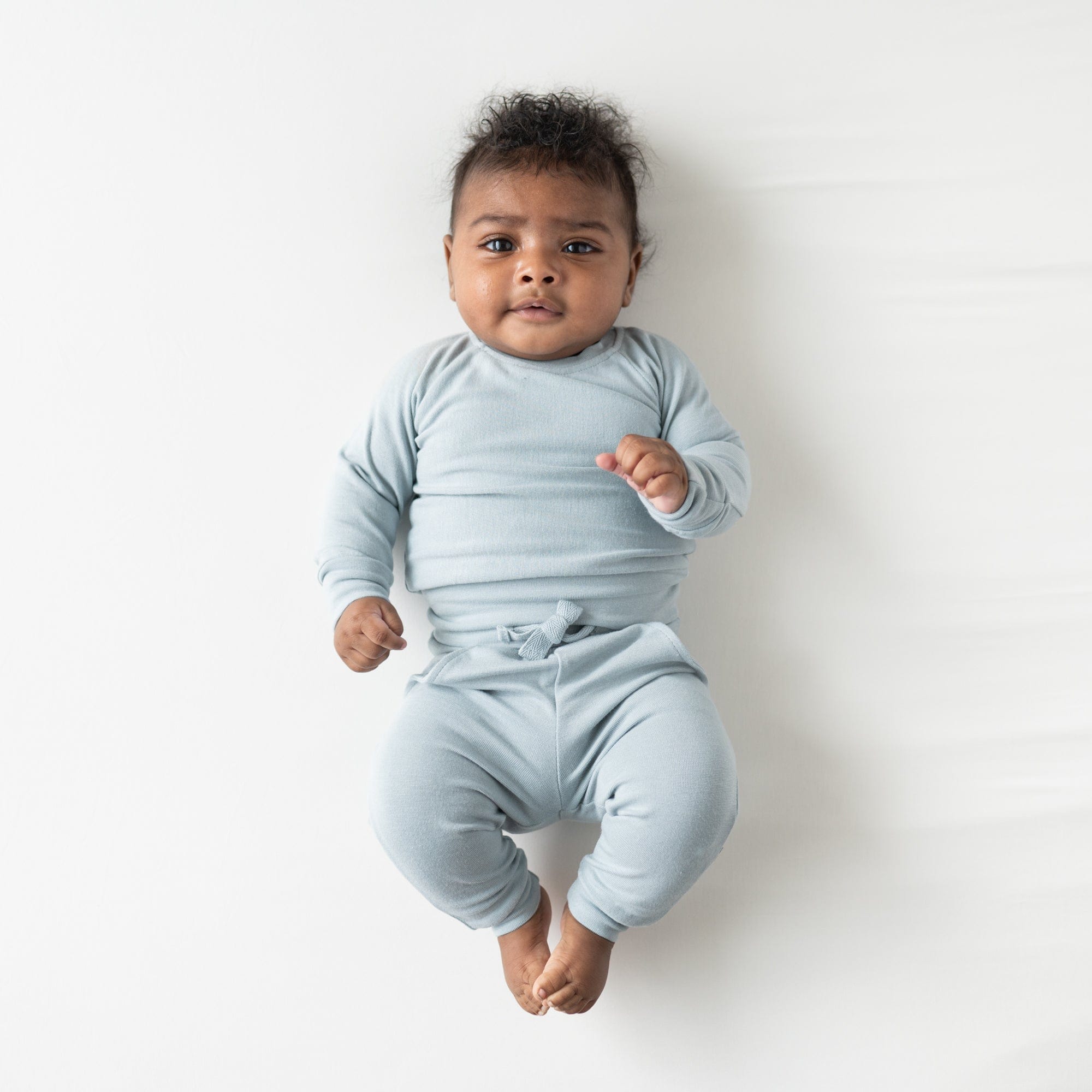 Infant wearing Kyte Baby Bamboo Jersey Jogger Set in Fog