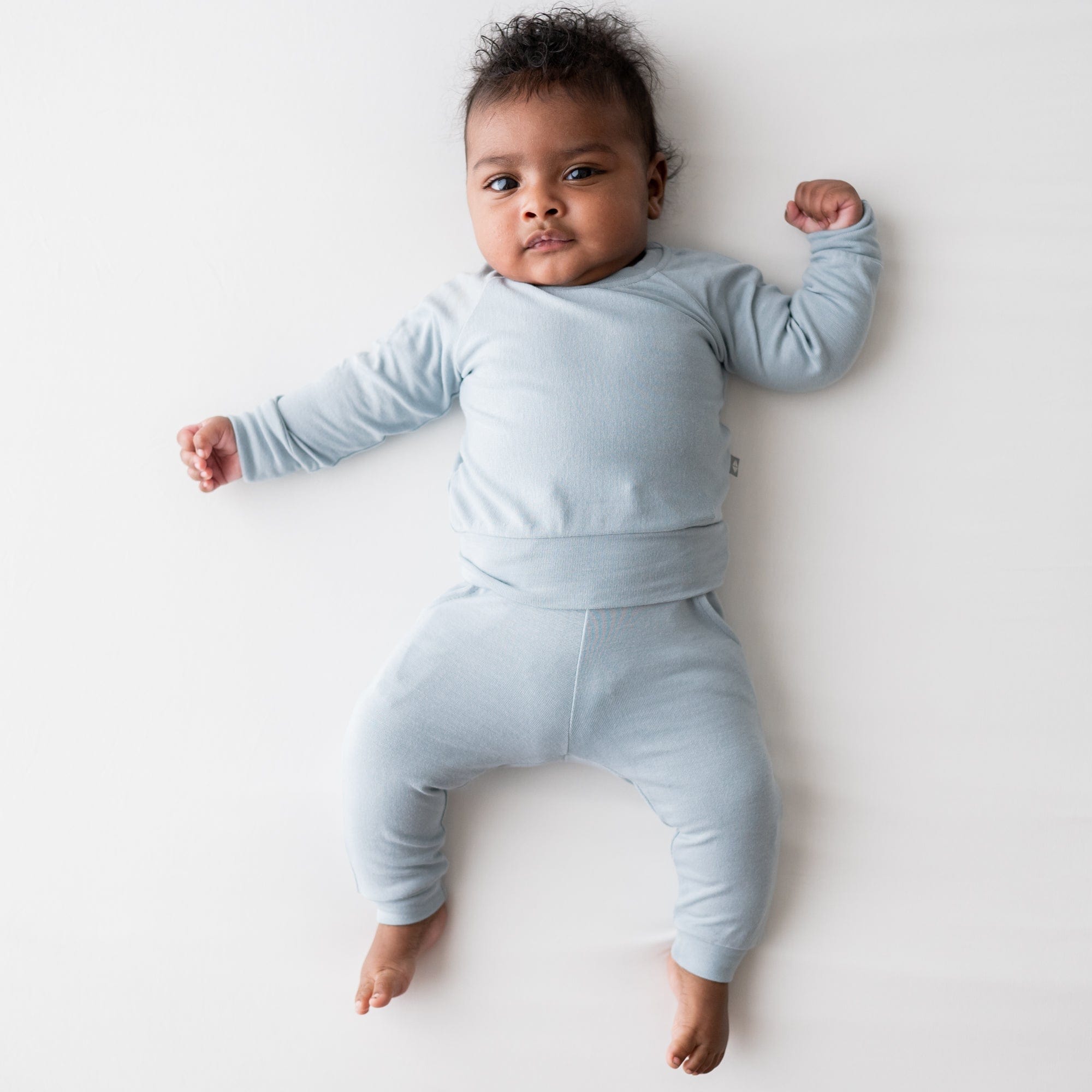 Infant wearing Kyte Baby Bamboo Jersey Jogger Set with drawstring waist in Fog