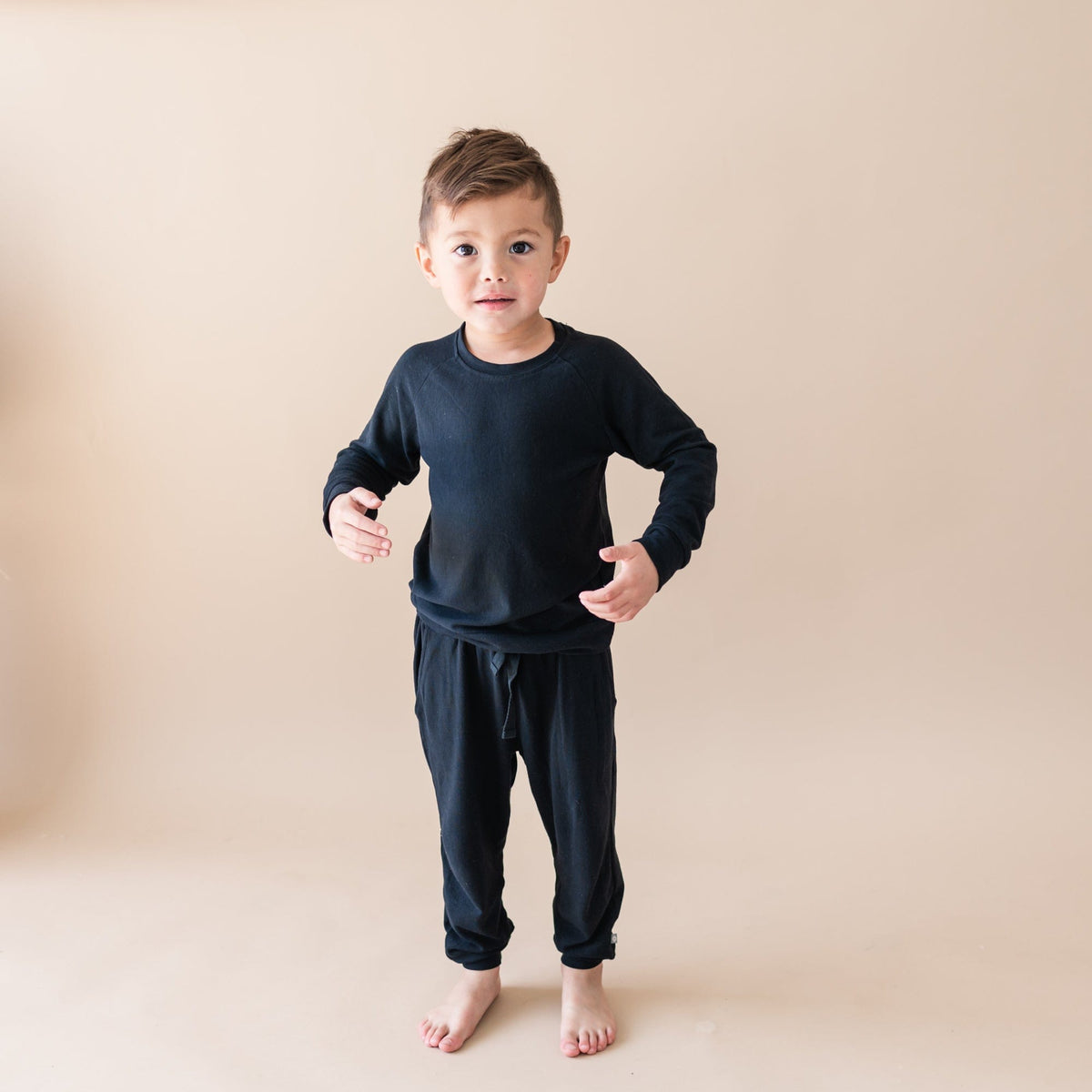 Toddler wearing Kyte Baby Bamboo Jersey Jogger Set in Midnight black