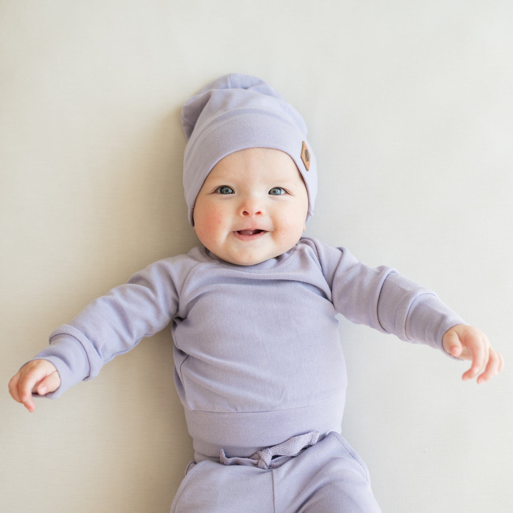 Infant wearing Kyte Baby Bamboo Jersey Jogger Set with drawstring waist in Taro