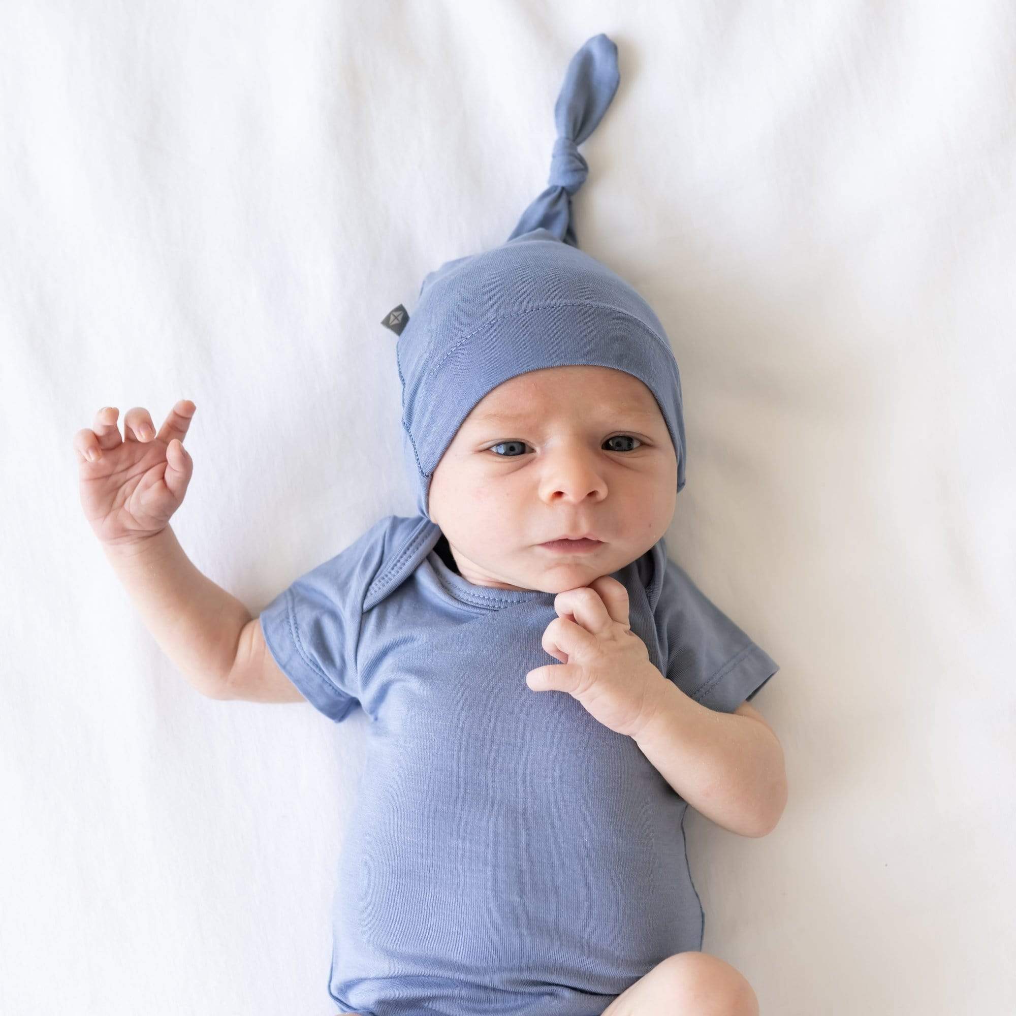 Newborn wearing Knotted Cap in Slate with a matching short sleeve bodysuit