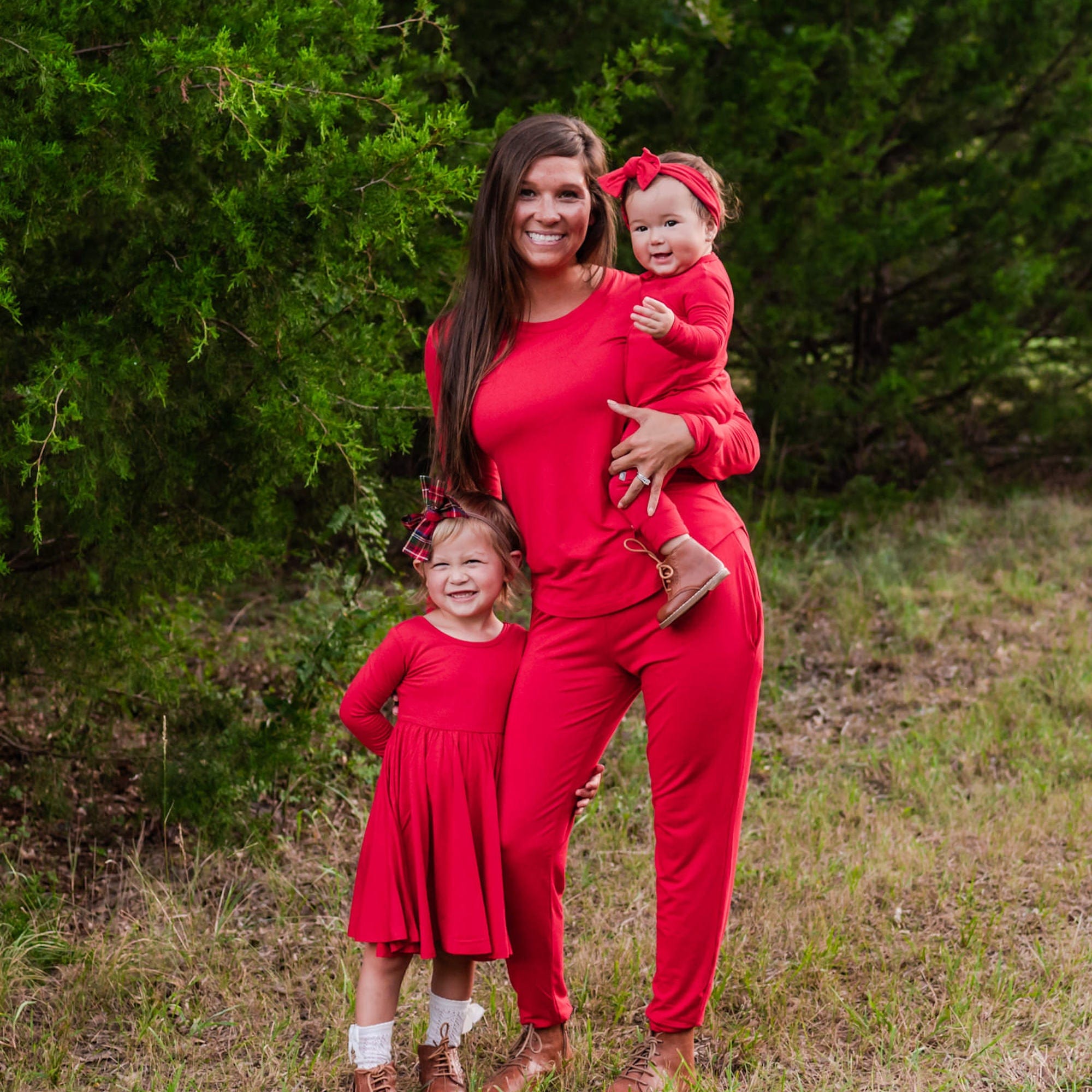 Family wearing Kyte Baby mommy and me matching outfits in Cardinal red