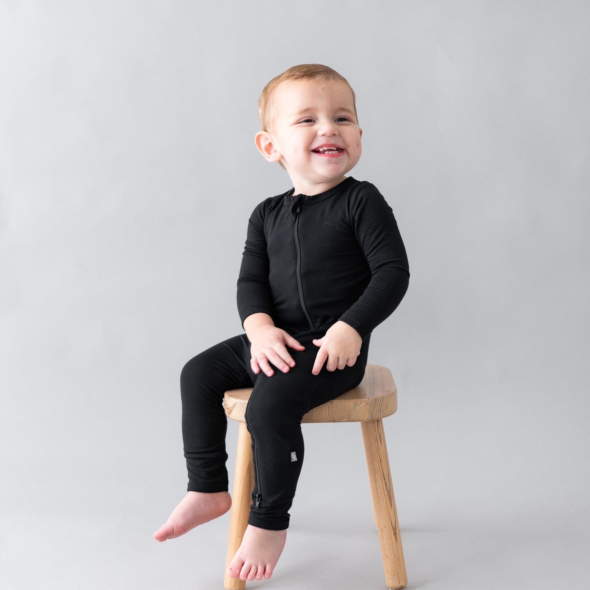 Toddler wearing Kyte Baby Zippered Romper in Midnight