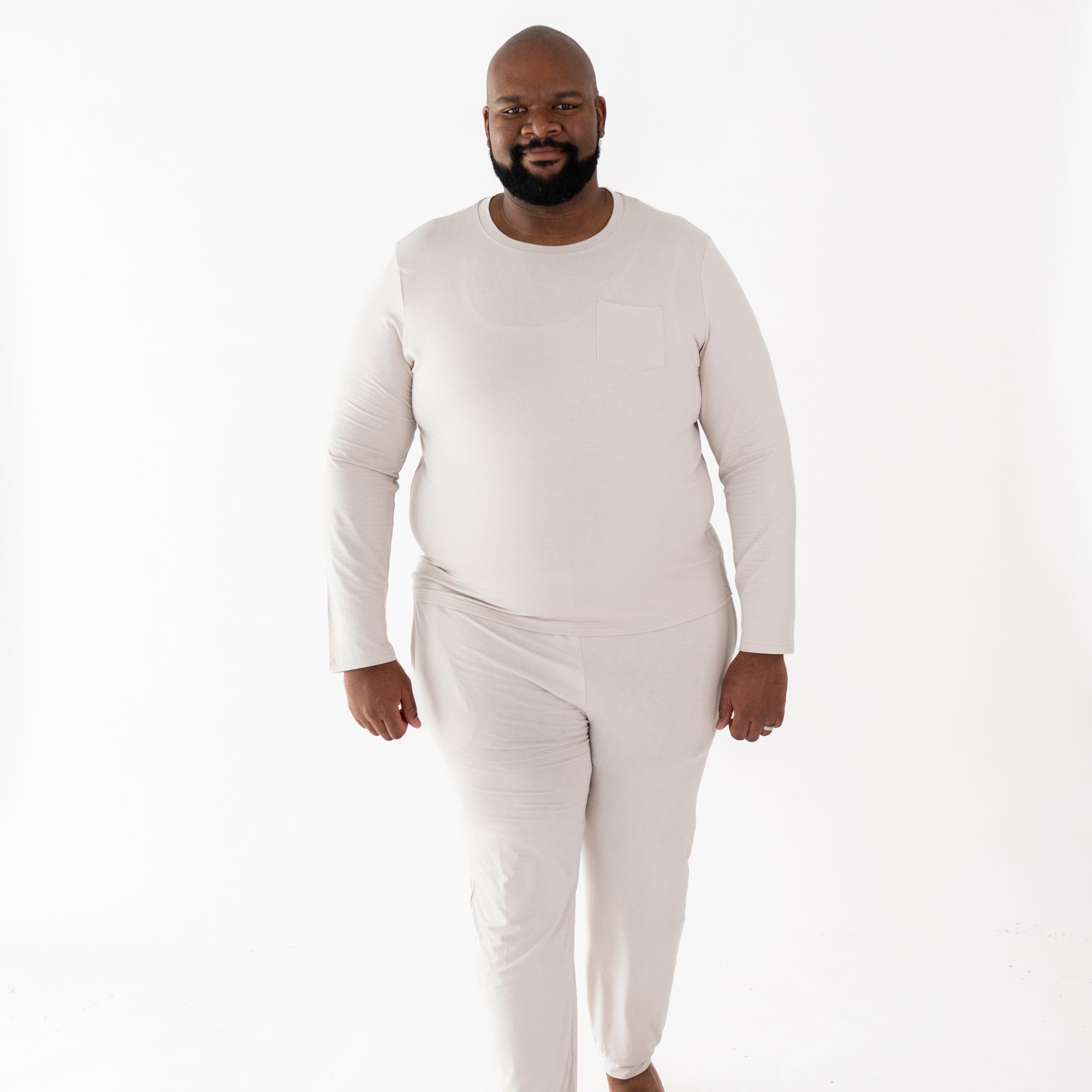 Man wearing Kyte Baby men's jogger set in Oat