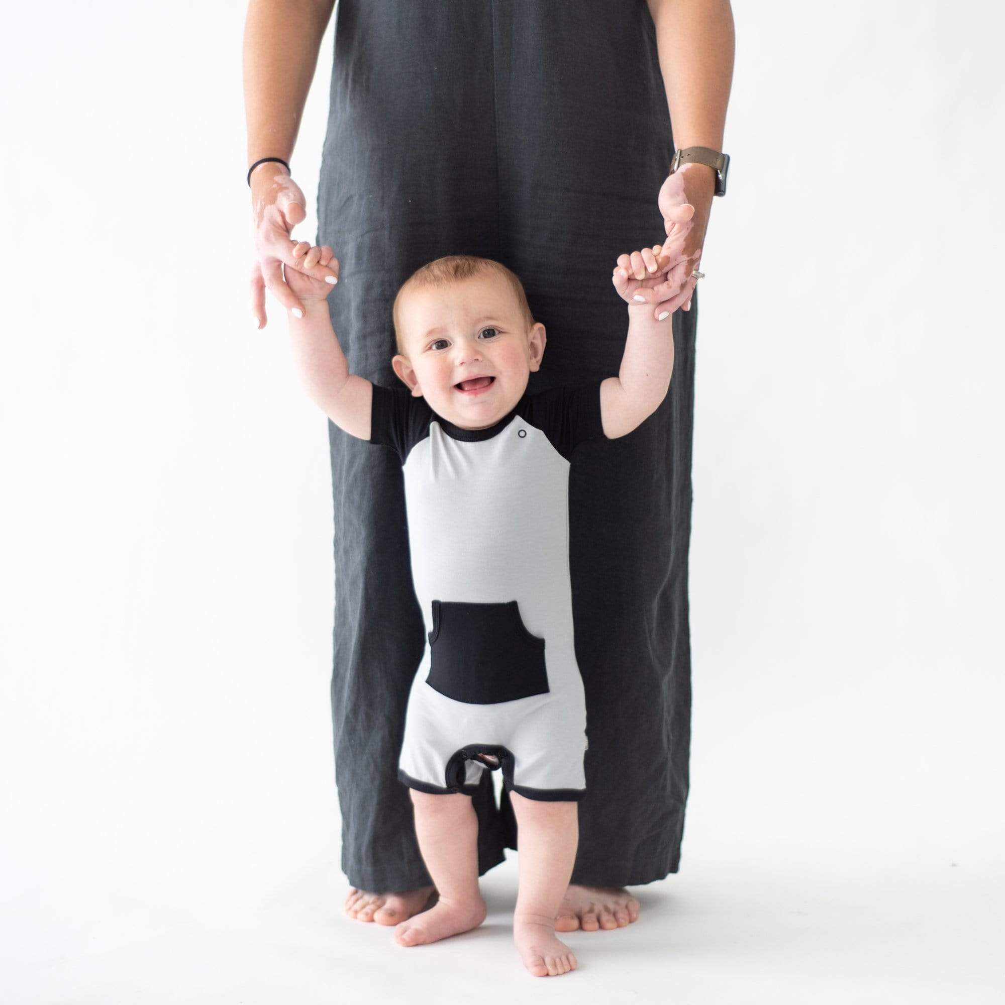 Infant wearing Kyte Baby Shortall in Storm
