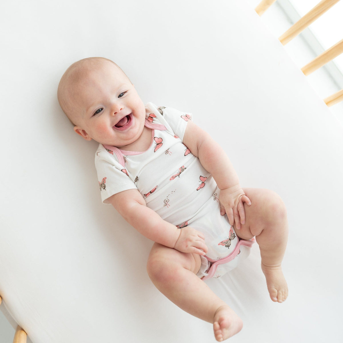 Newborn wearing Kyte Baby Bodysuit in Butterfly